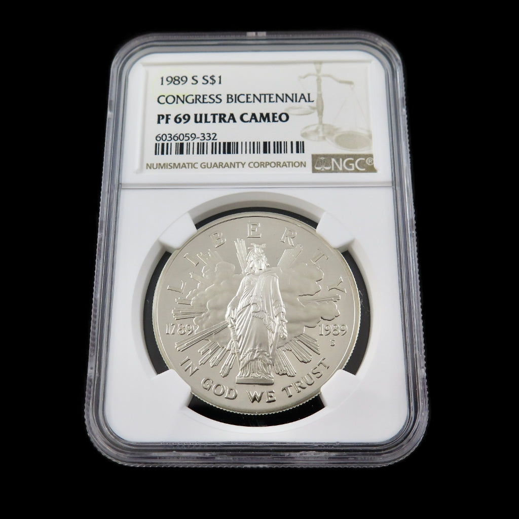 Silver dollar coin 1989-S Congress commemorative with PF69 ultra cameo grade, graded by NGC, showcasing detailed design and reflective surface.