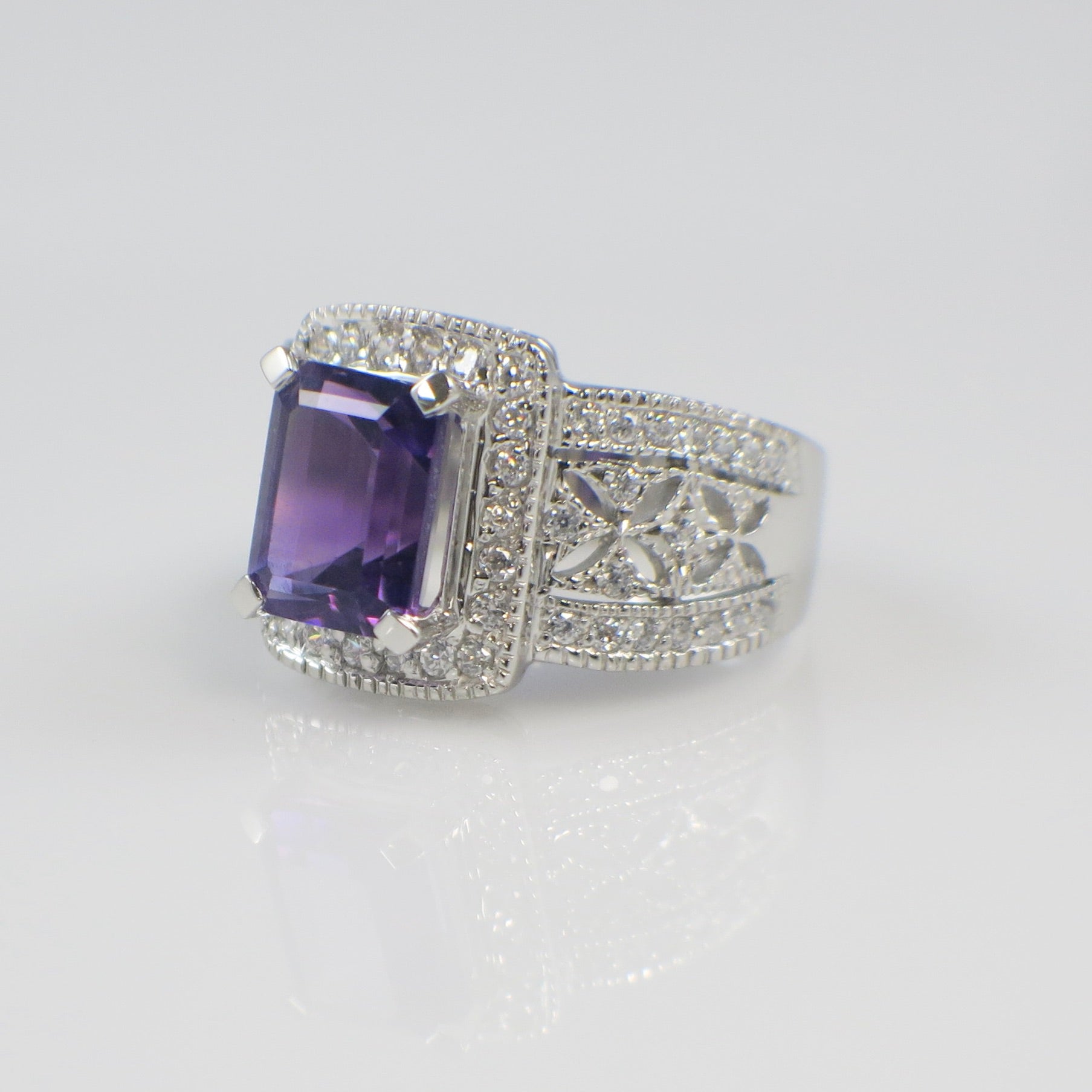 Silver ring with a purple gemstone on a white background