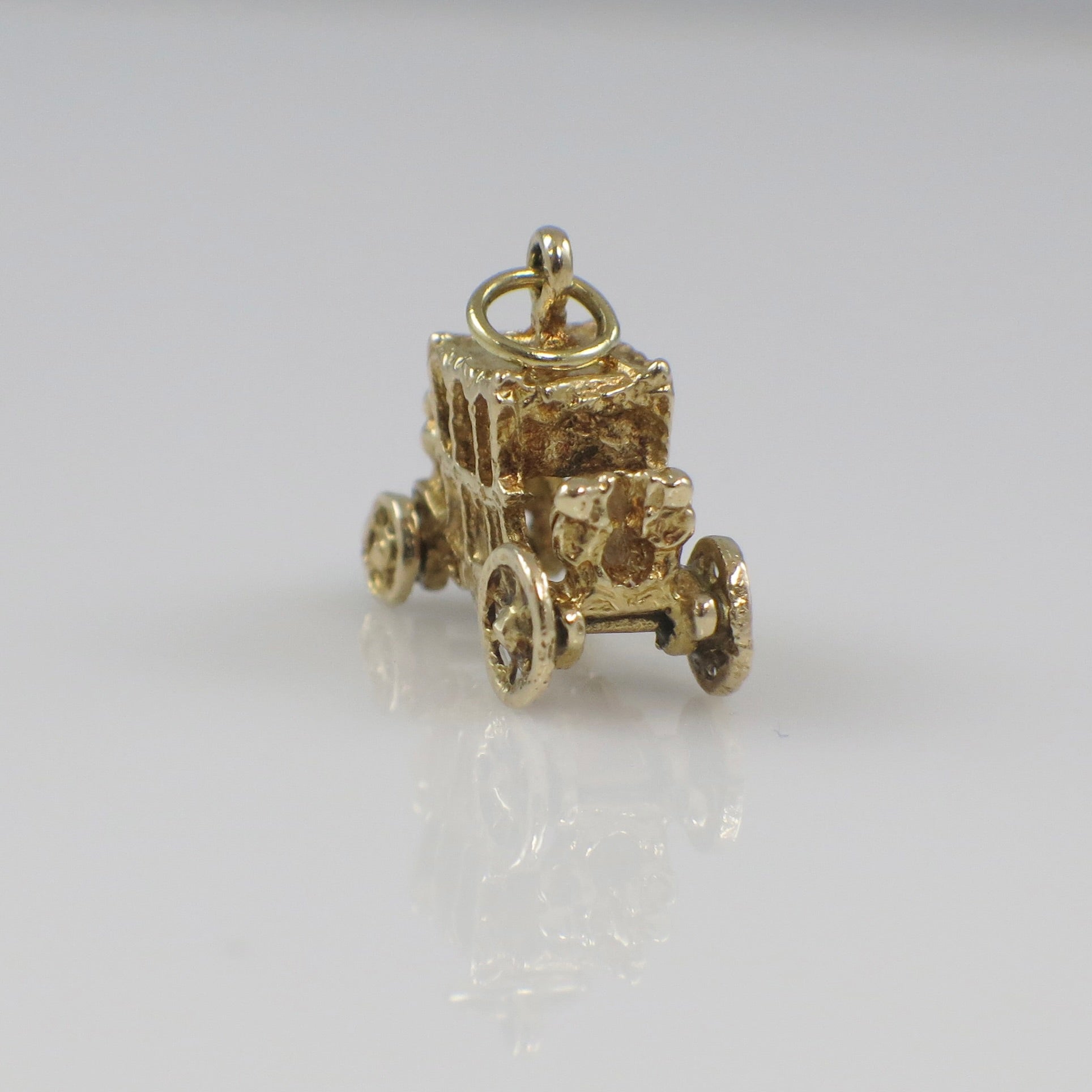 14K yellow gold carriage charm pendant with vintage style details, solid gold jewelry piece showcasing intricate craftsmanship.