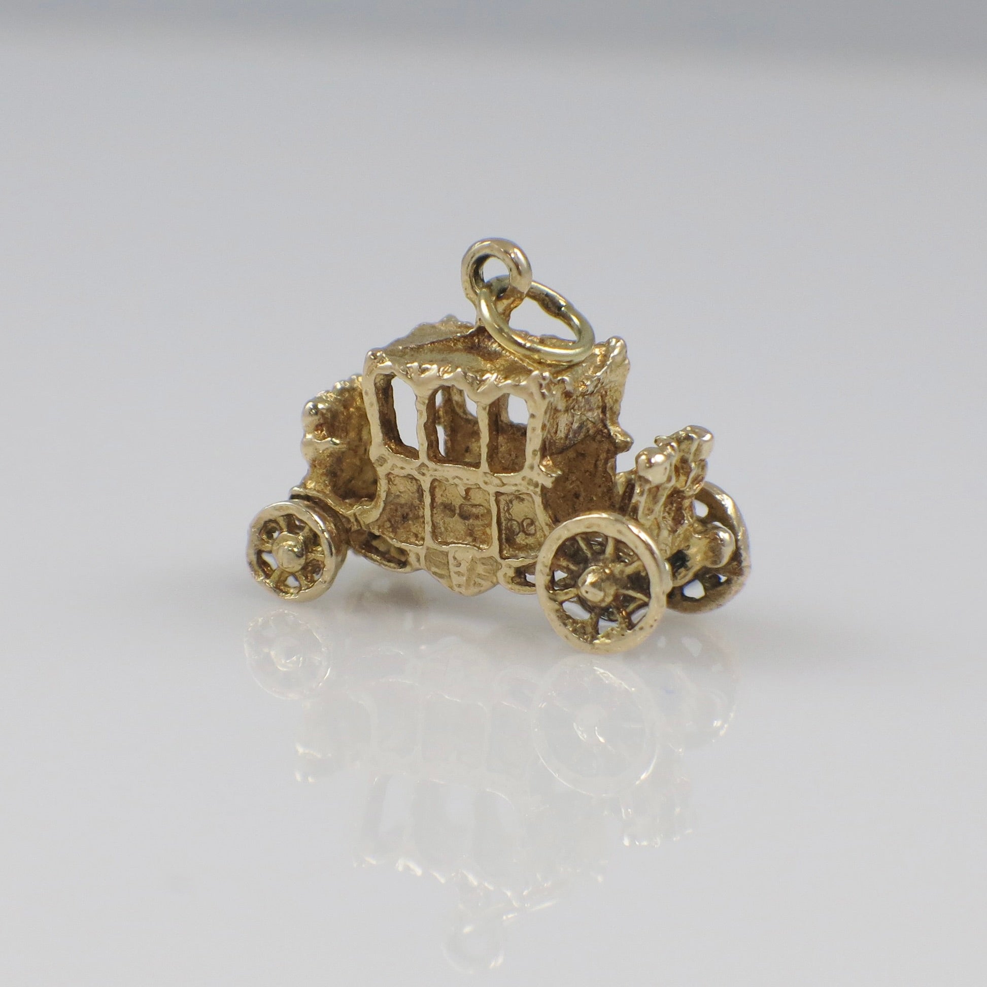 Vintage 14K yellow gold carriage charm pendant with intricate detailing, solid gold charm for jewelry accessories.