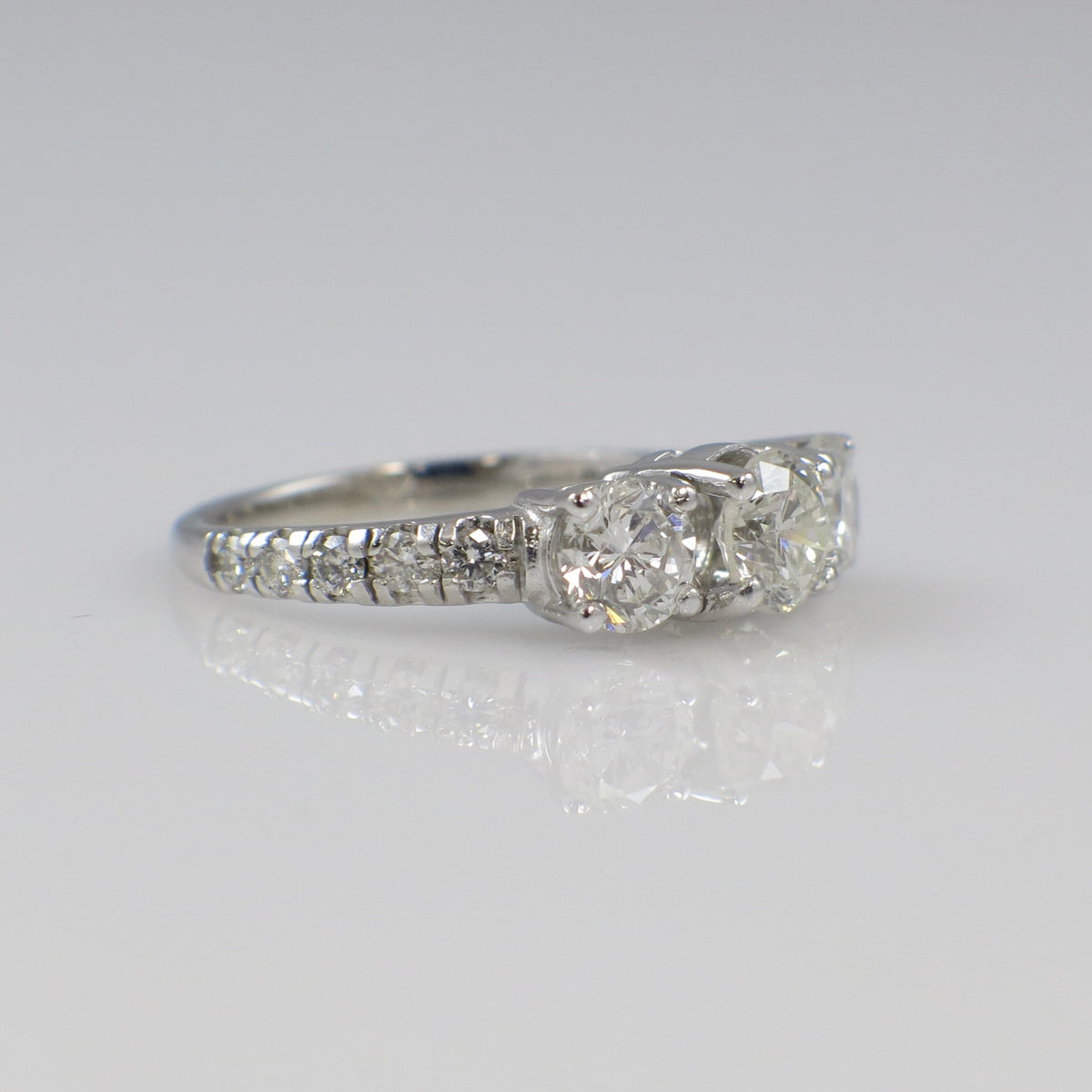 Vintage 18K white gold three-stone diamond engagement ring with 1.92 carats from Lillian James Bridal, featuring sparkling diamonds.