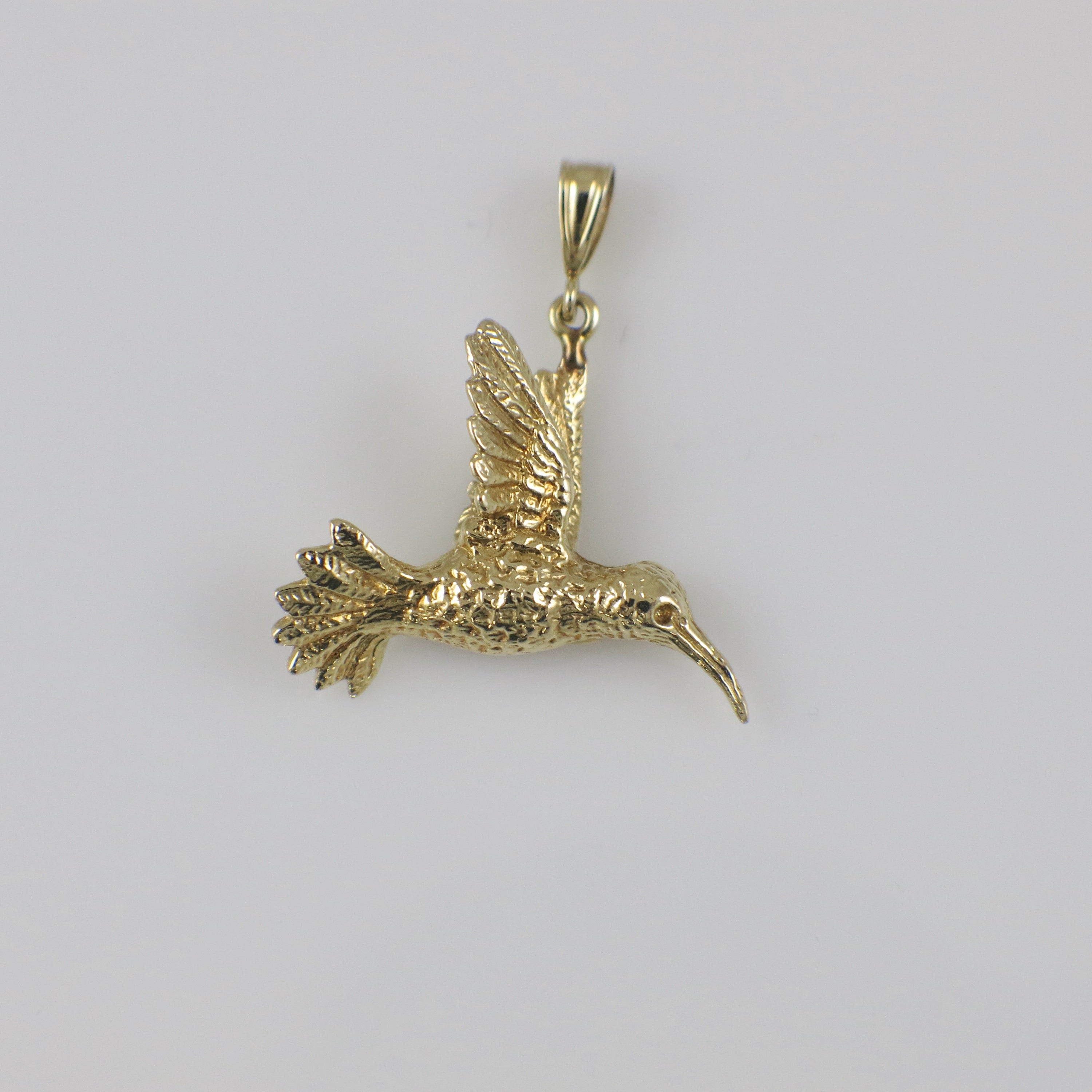 14K yellow gold hummingbird charm pendant with intricate detailing, crafted by Black Market LLC.