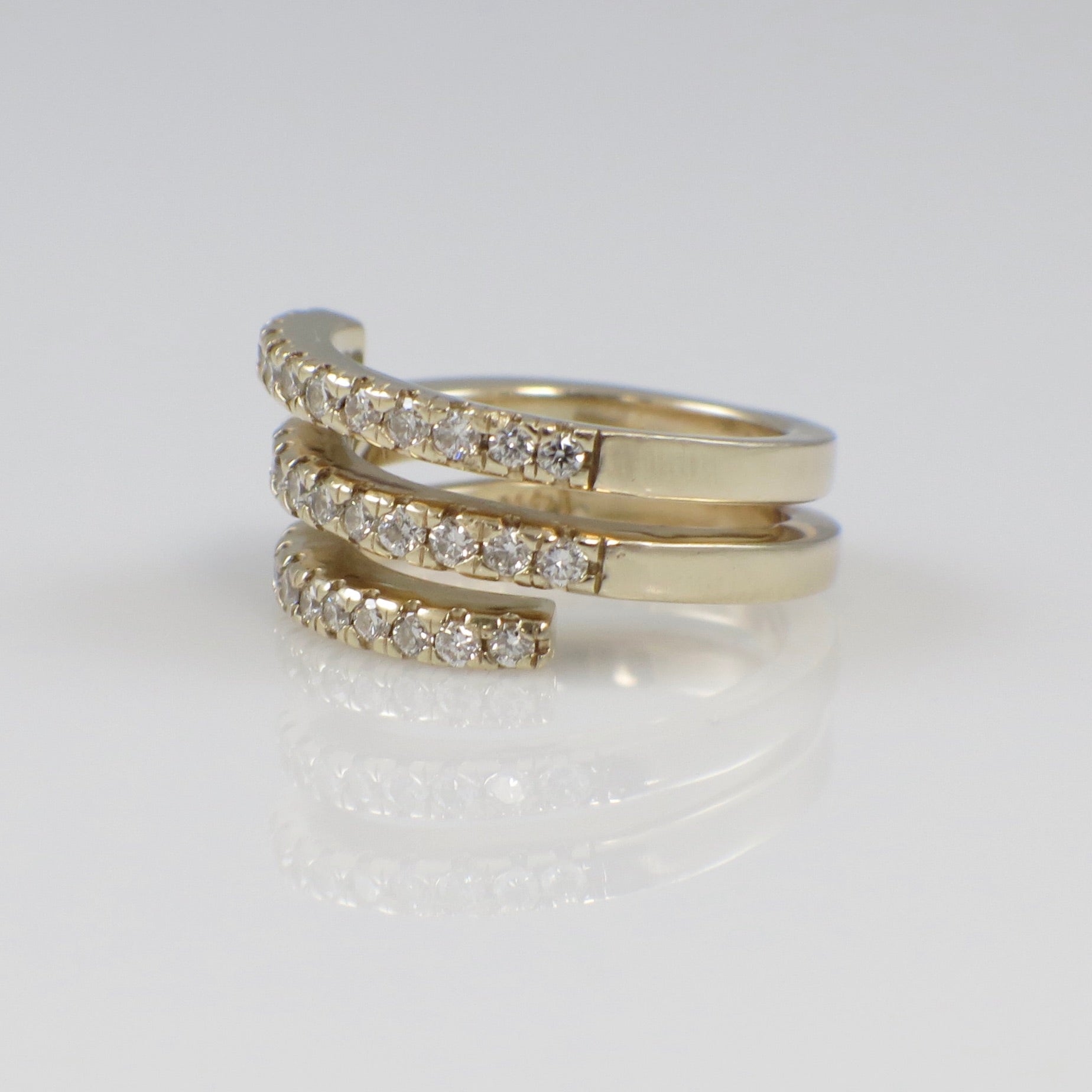 14K yellow gold CZ wrap ring with three bands and cubic zirconia accents, size 4, featuring a sleek, modern design.