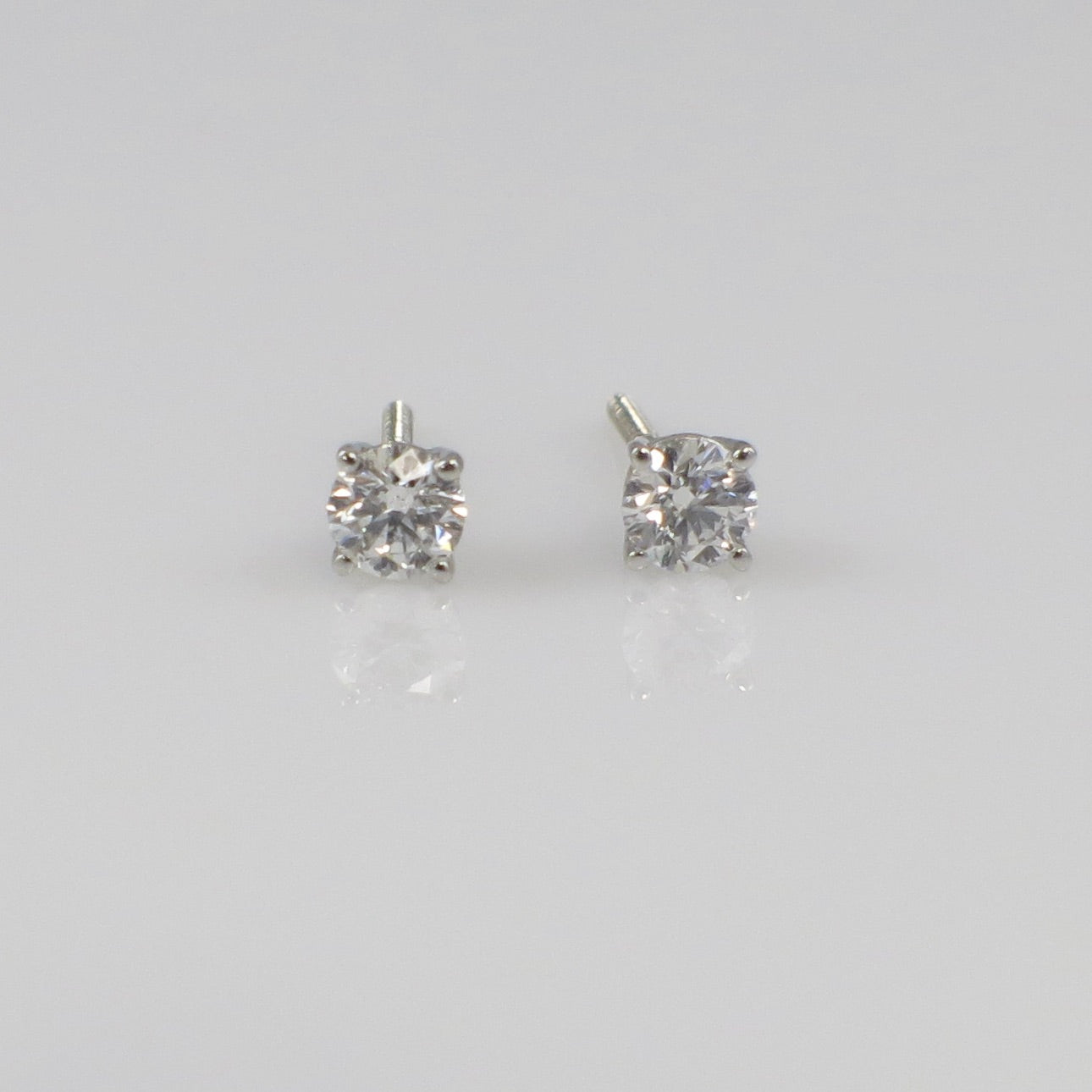 Natural diamond stud earrings with 0.30 CTW in 14K white gold, featuring threaded backs and sparkling round diamonds.