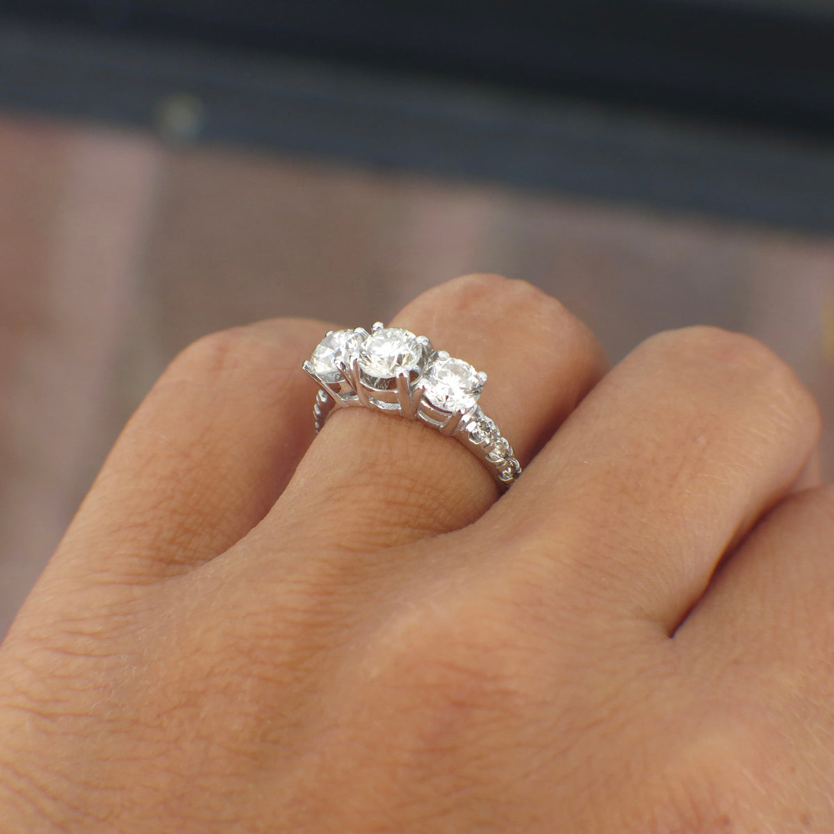 Vintage Lillian James bridal 18K white gold three stone diamond engagement ring with 1.92 CTW featuring three sparkling diamonds.