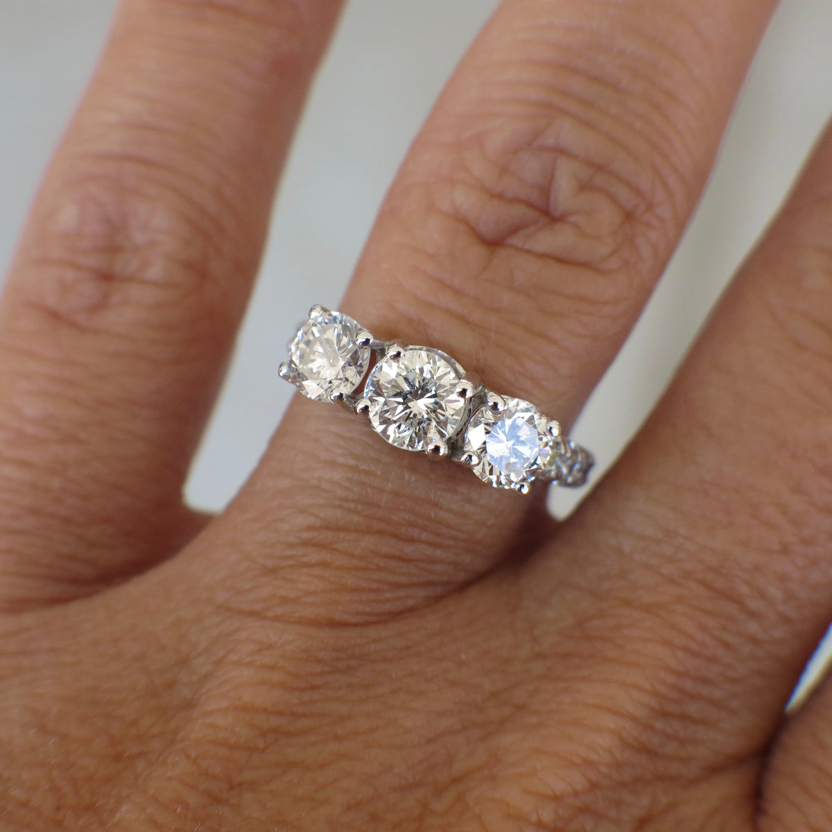 Vintage Lillian James bridal 18K white gold three stone diamond engagement ring with 1.92 CTW, showcasing sparkling diamonds and elegant design.