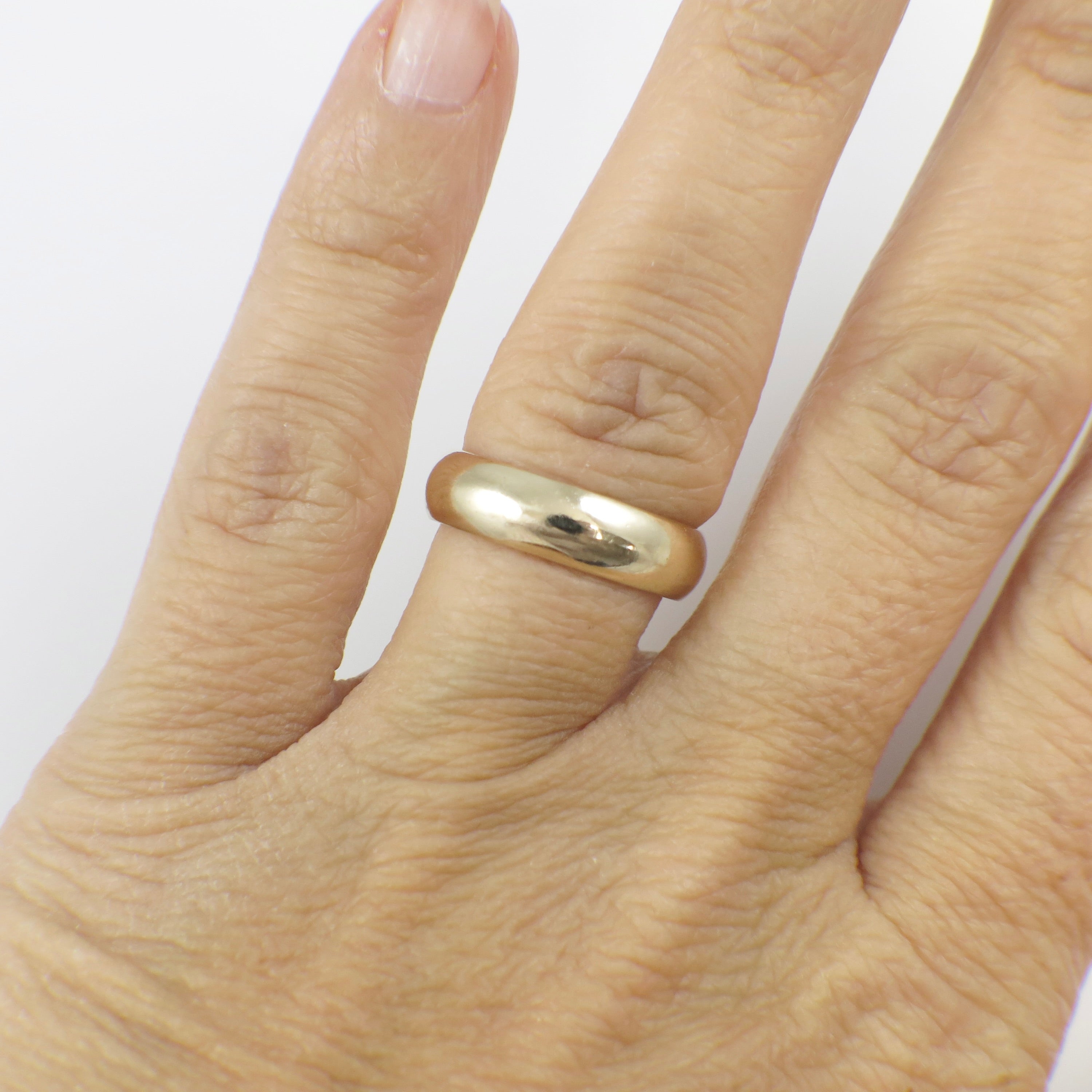 14K yellow gold wedding band ring, 5mm width, classic design, size 5, by Black Market LLC, displayed on a neutral background.