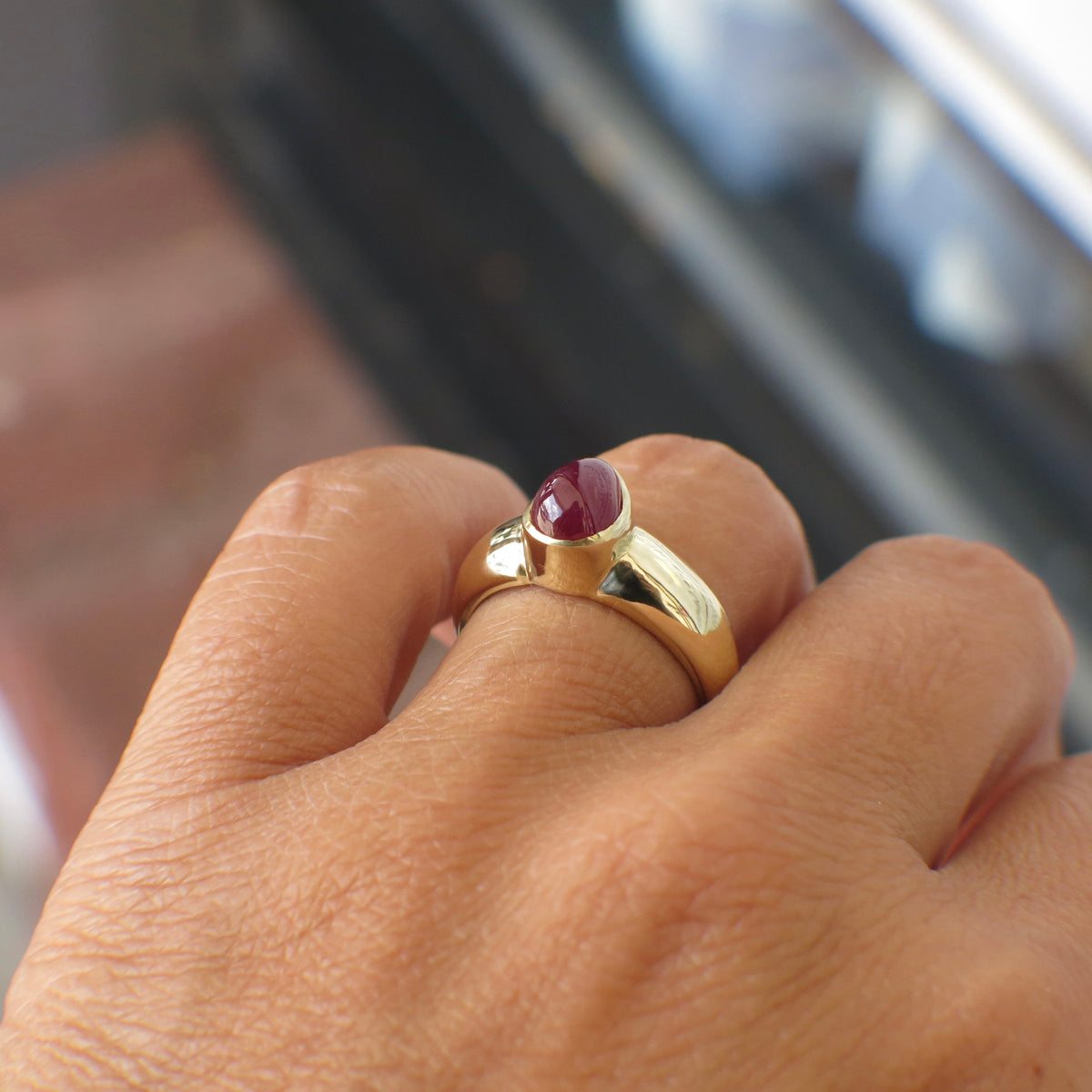 Vintage 14K yellow gold ring featuring a pear-shaped cabochon ruby bezel setting, showcasing elegant craftsmanship.