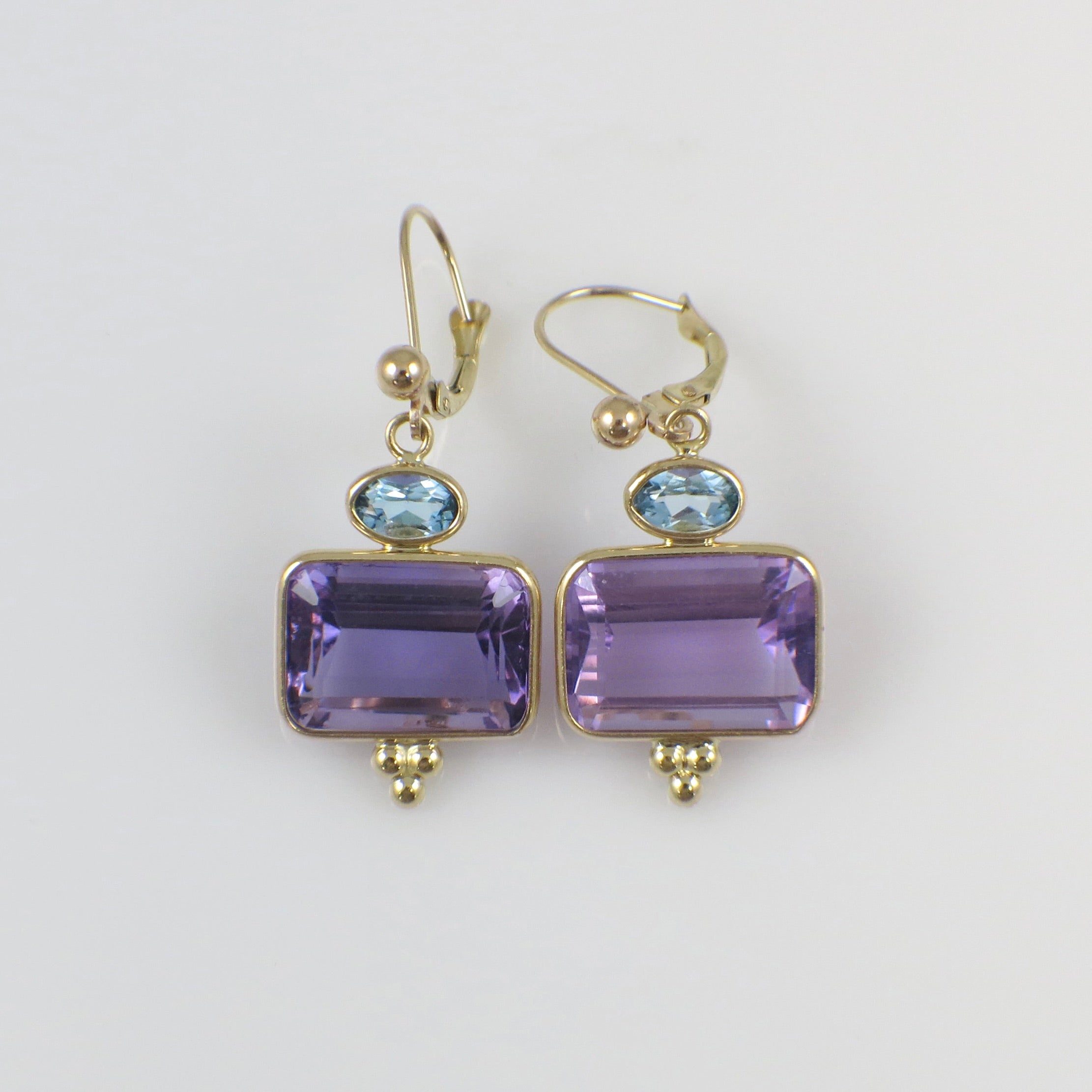 Vintage 14K yellow gold amethyst and topaz drop earrings with intricate design and elegant dangle style.