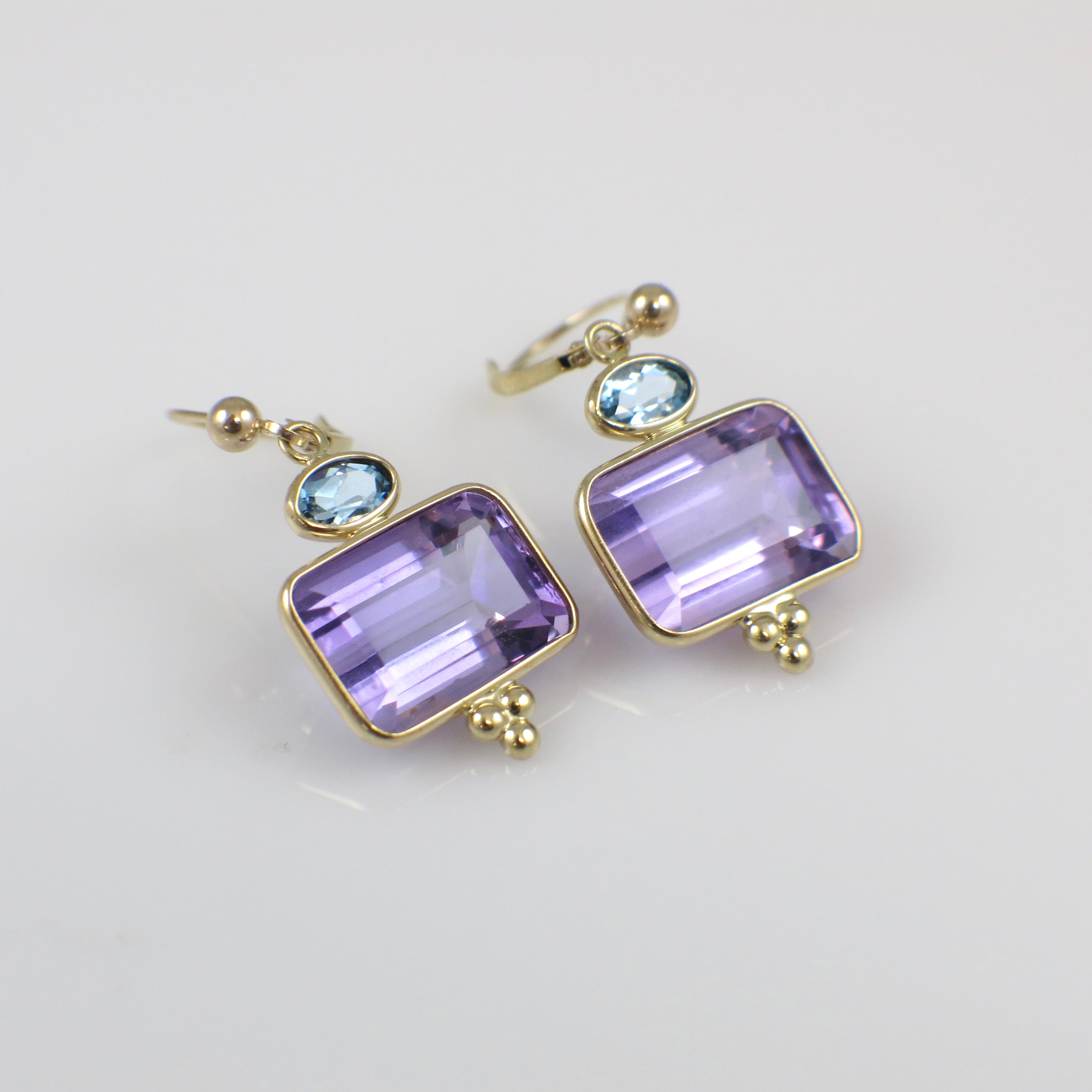 Vintage 14K yellow gold amethyst and topaz drop earrings with intricate detailing and elegant design.
