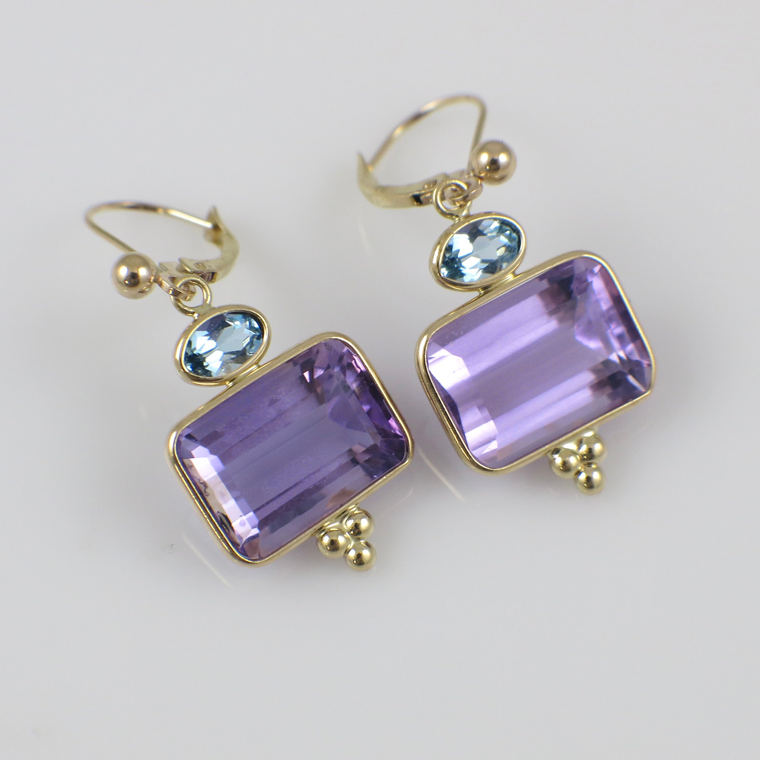 Vintage 14K yellow gold amethyst and topaz drop earrings featuring elegant gemstone settings and classic earring design.