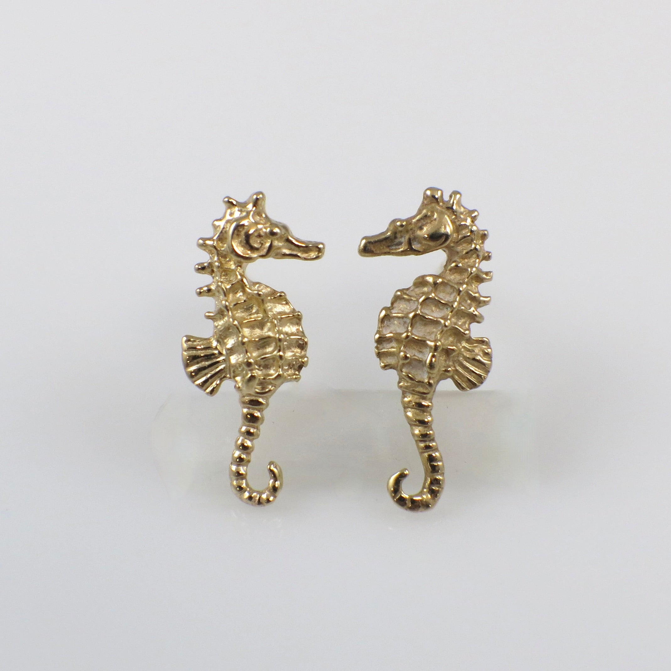 Vintage 14K yellow gold seahorse stud earrings featuring detailed marine-inspired design, by Black Market LLC.