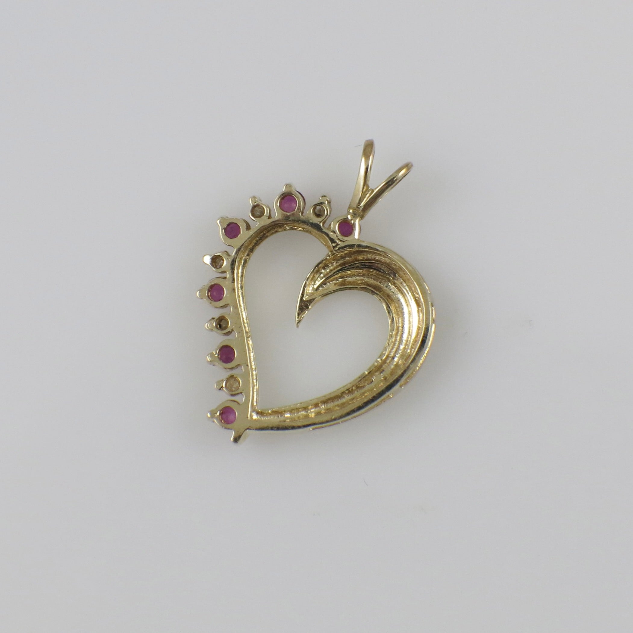 Vintage 14K yellow gold ruby and diamond heart pendant necklace with intricate detailing.