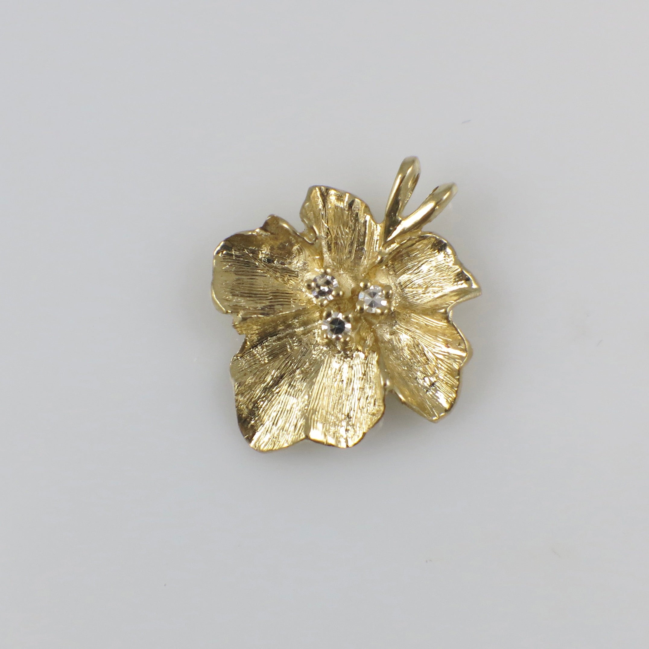 Vintage 14K yellow gold diamond floral pendant necklace with intricate floral design, crafted by Black Market LLC.
