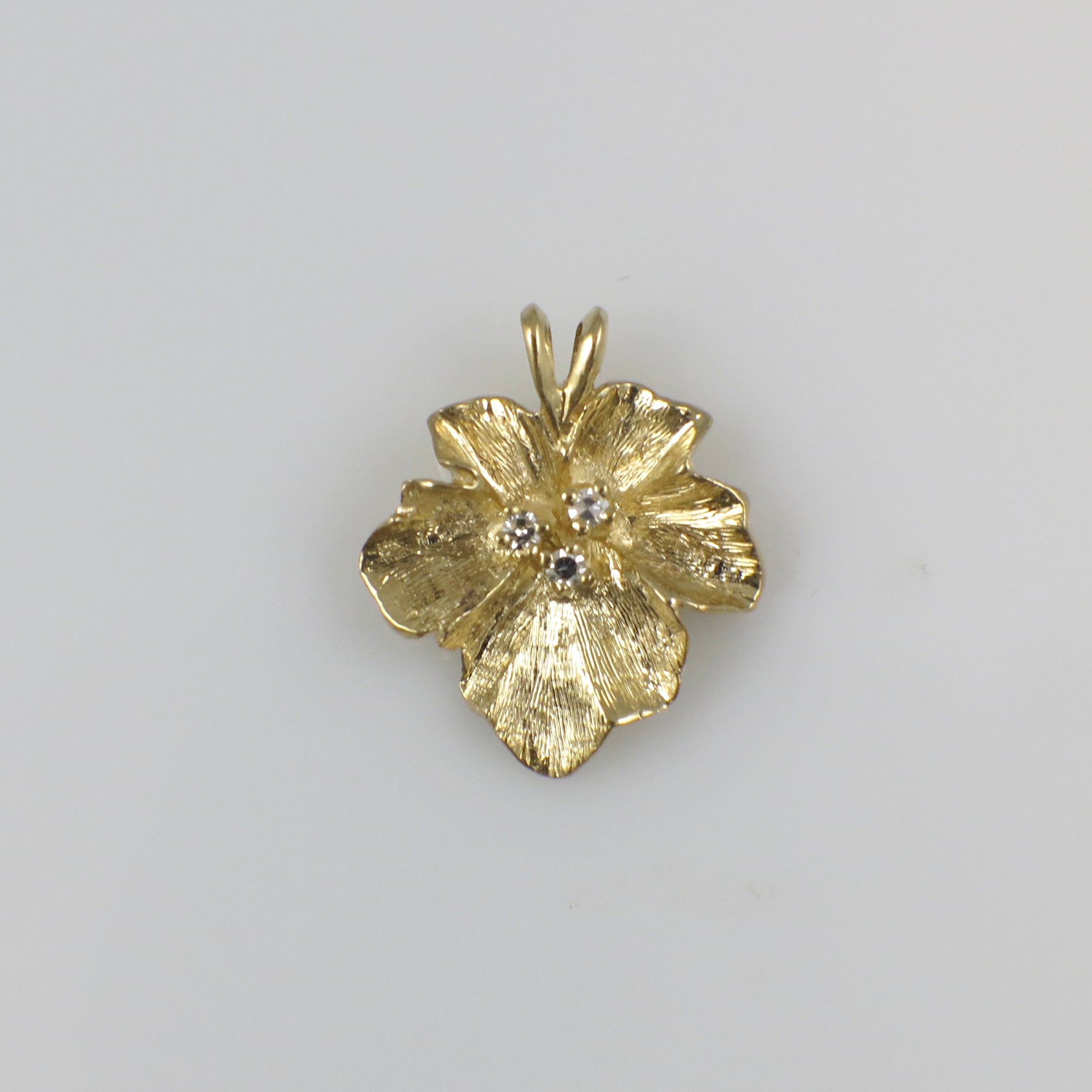 Vintage 14K yellow gold diamond floral pendant necklace with intricate design and sparkling diamonds.