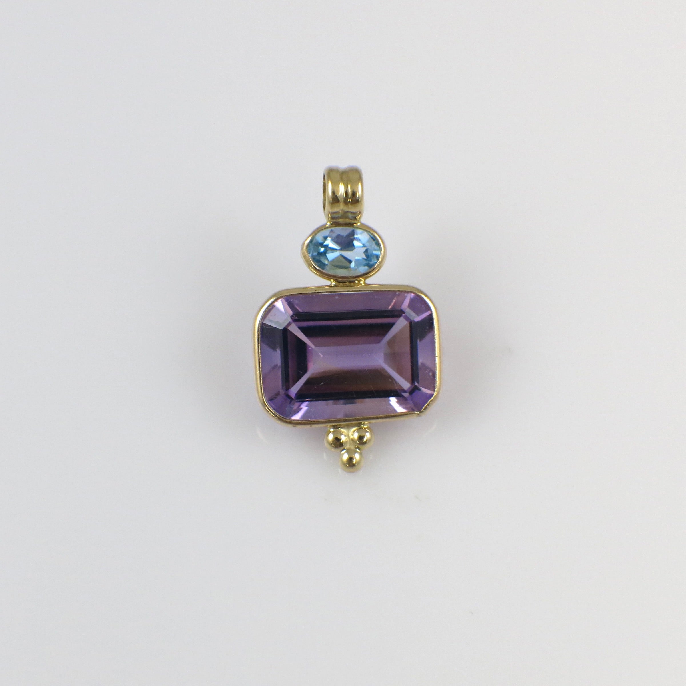Vintage 14K yellow gold amethyst and Swiss blue topaz pendant necklace with intricate design.