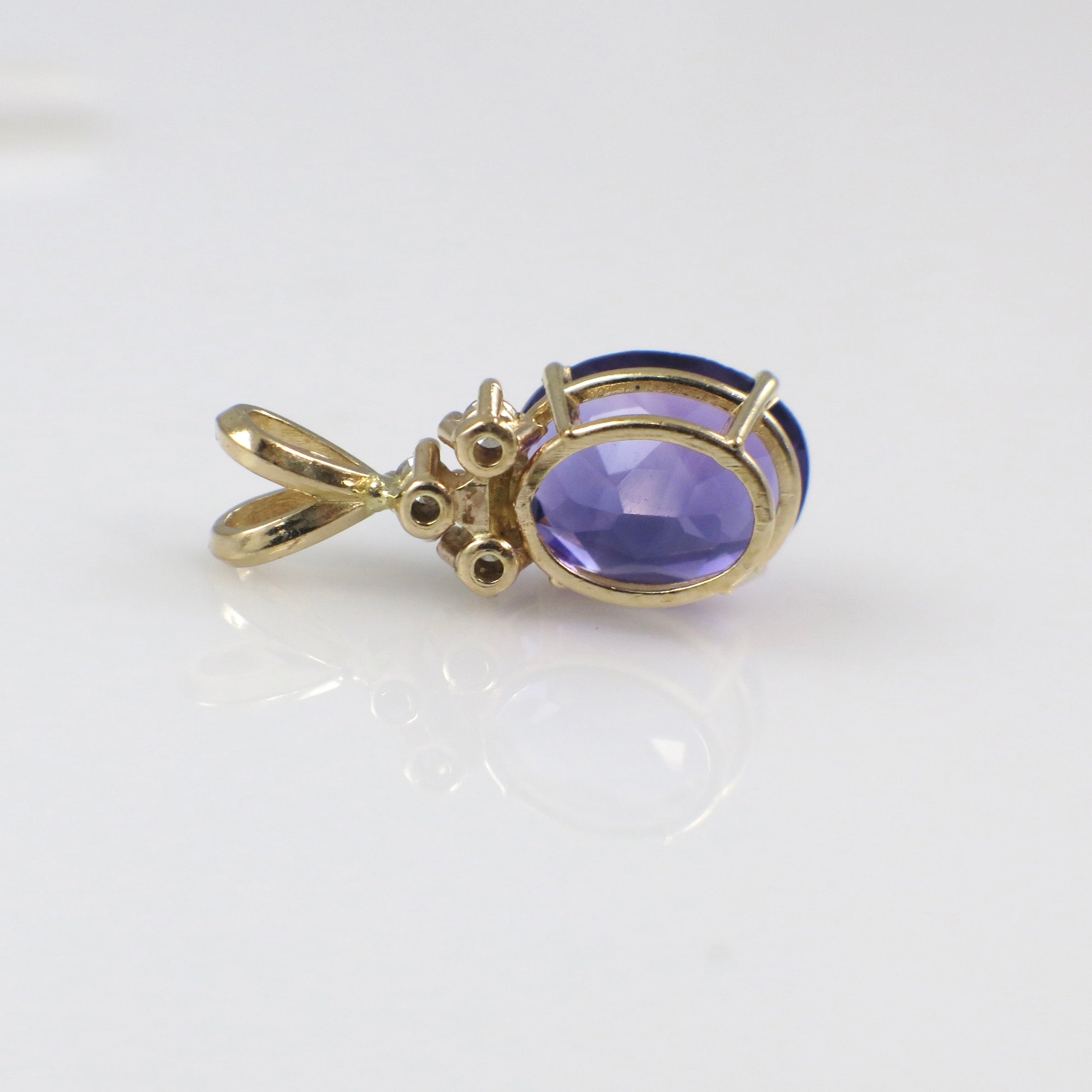 Vintage 14K yellow gold amethyst and diamond pendant necklace with intricate design, from Black Market LLC.
