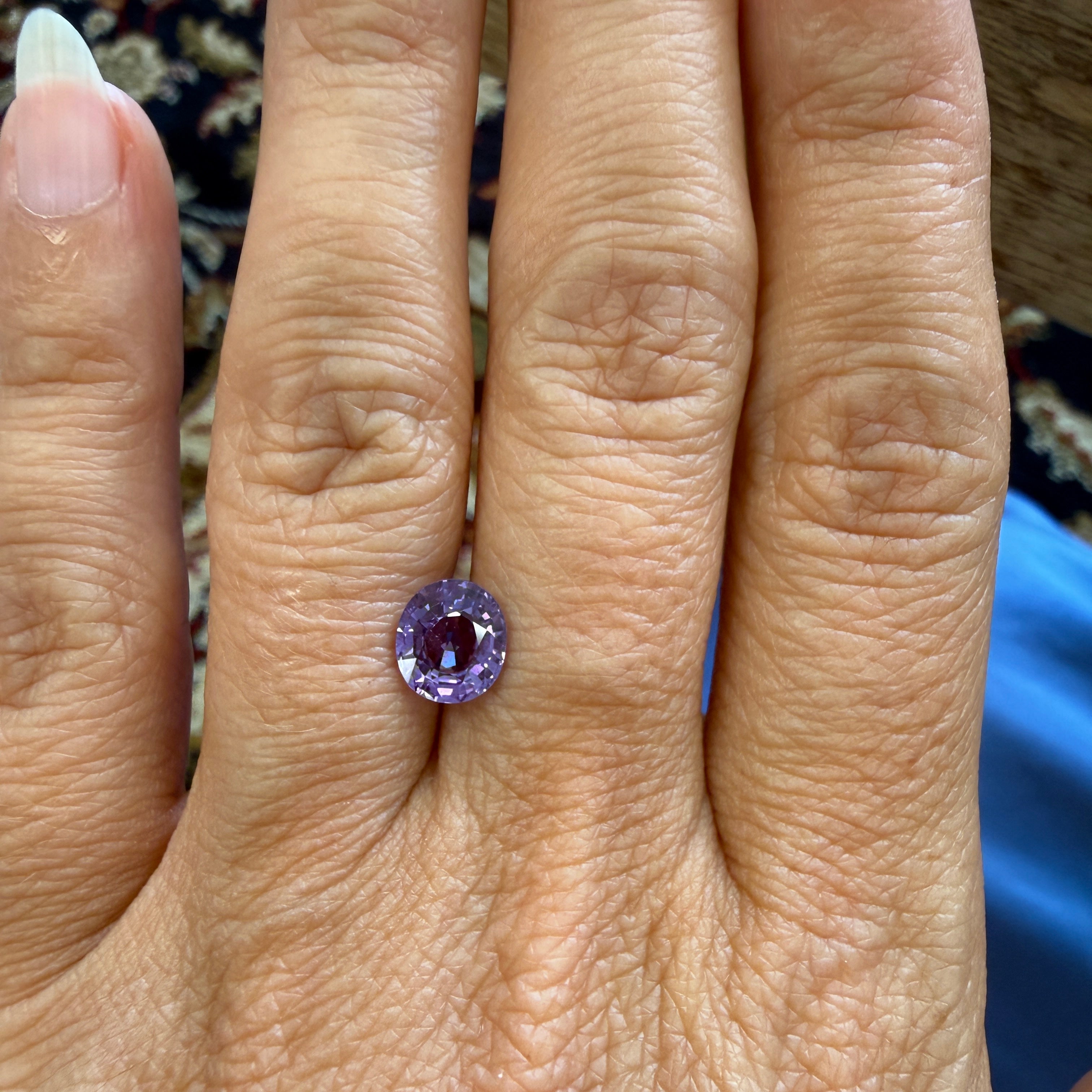 Unheated purple sapphire gemstone in oval cut, 1.69ct, natural sapphire from Black Market LLC, measuring 7.62 x 6.71mm.