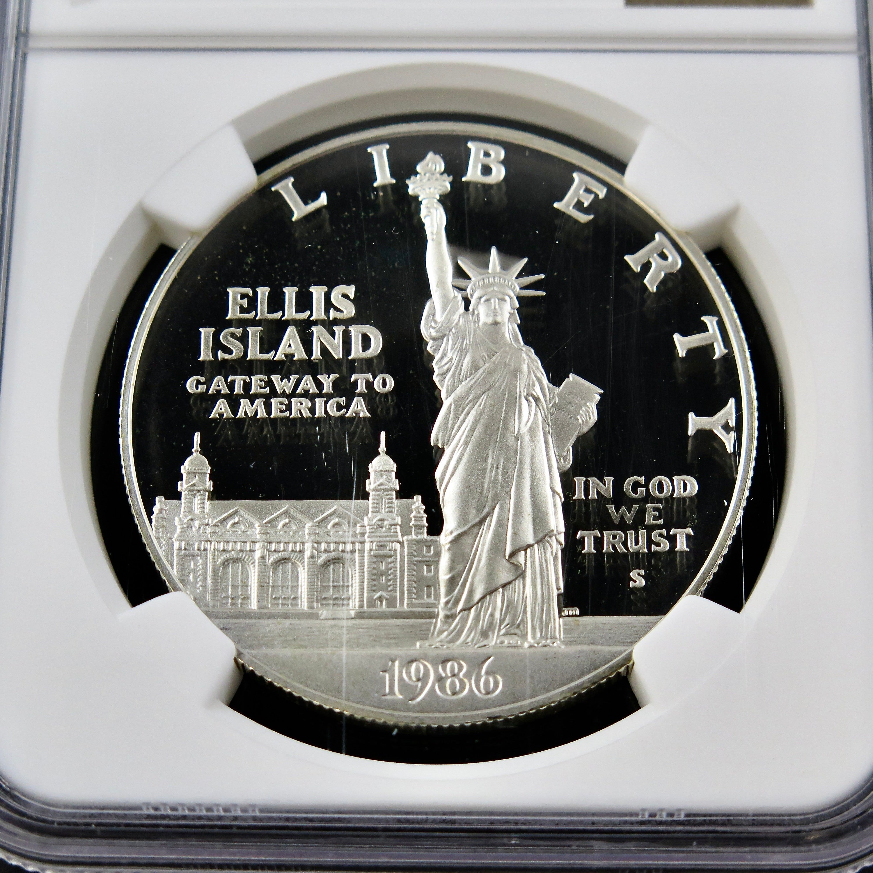 Silver dollar coin 1986-S Liberty commemorative in ultra cameo proof finish, graded PF69 by NGC, featuring detailed design and reflective surfaces.