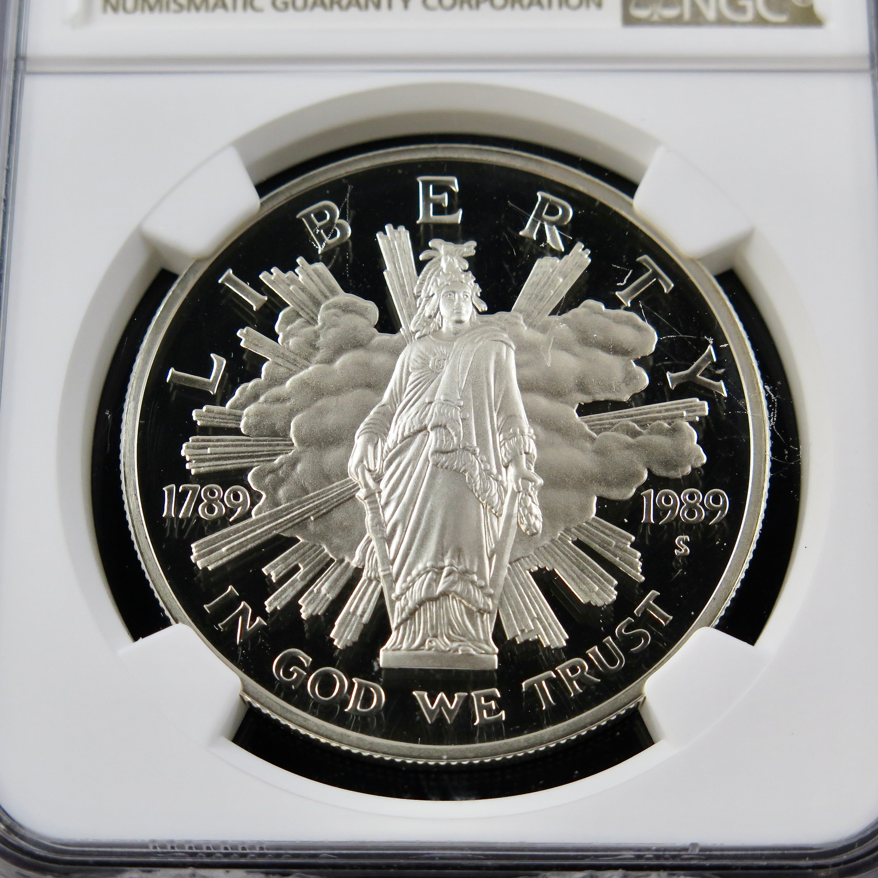 Silver dollar coin 1989-S Congress commemorative with Ultra Cameo finish, graded PF69 by NGC, showcasing intricate design details.