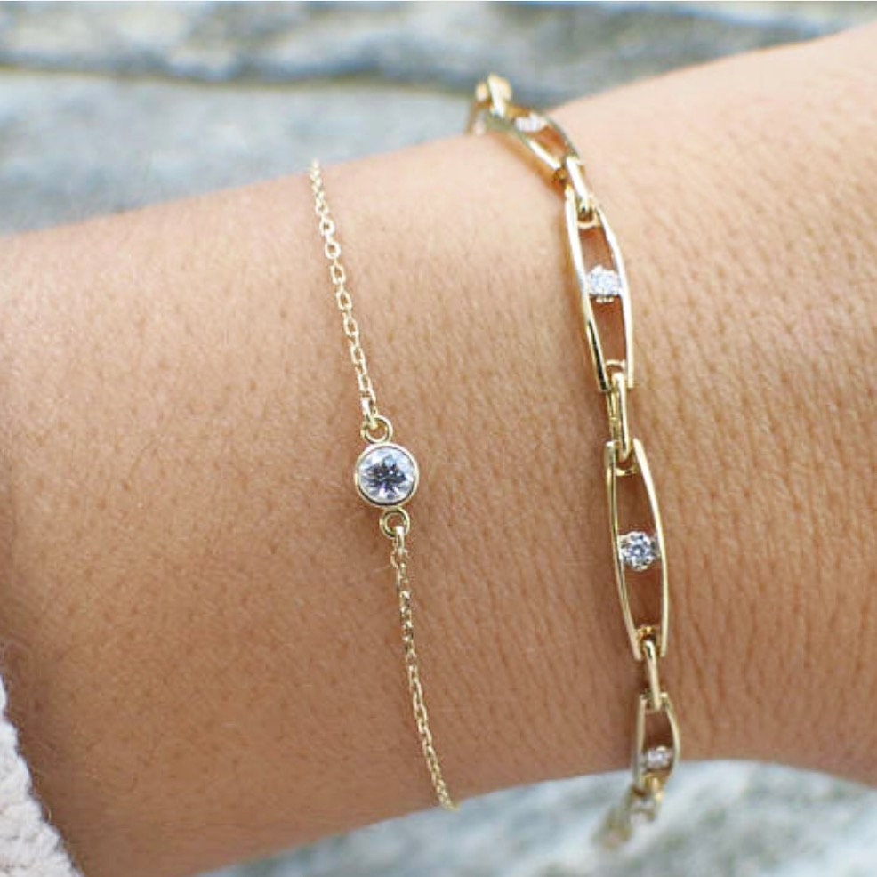 14K gold diamond bezel bracelet by Black Market LLC with dainty design and 0.10 CT diamonds, perfect for layering jewelry.