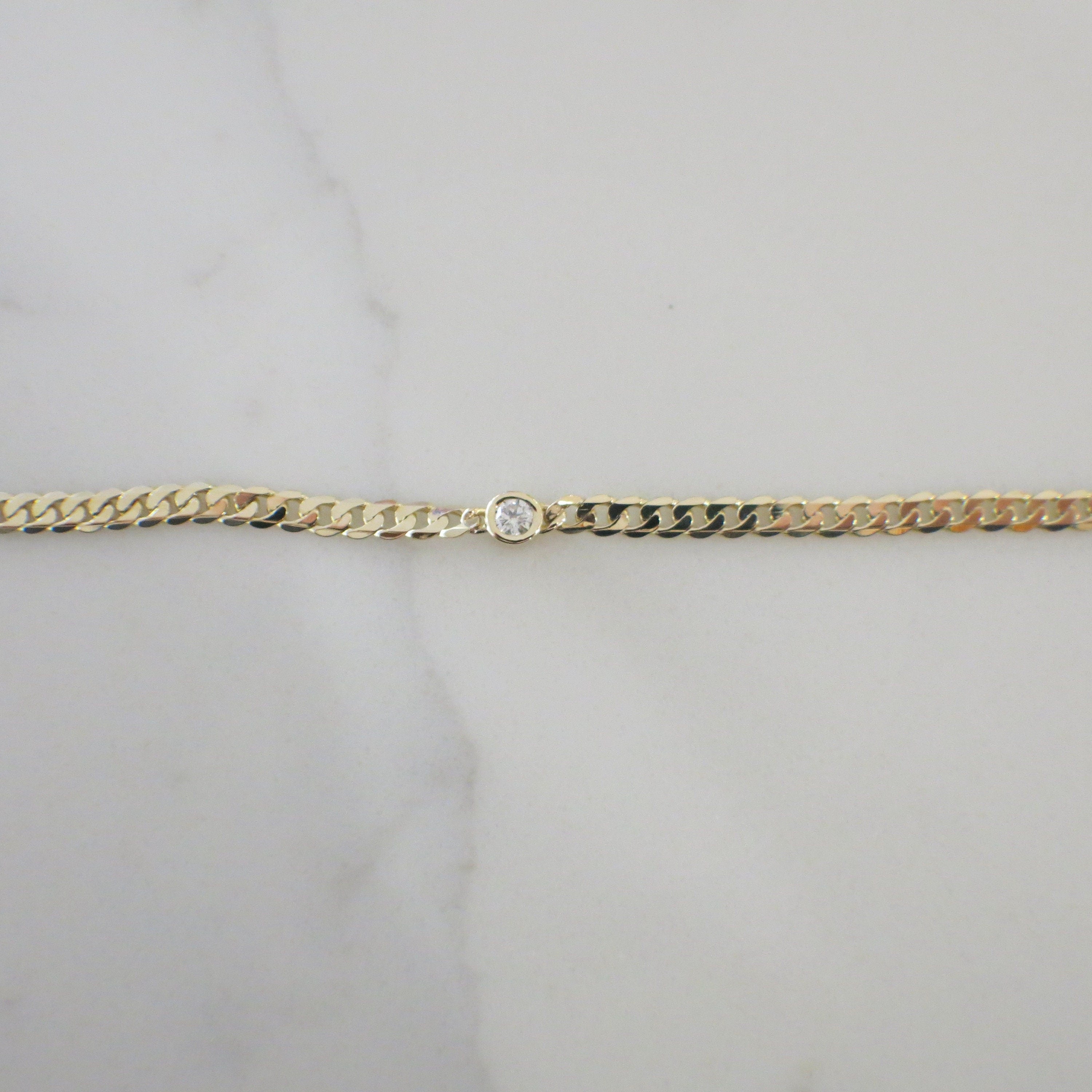 14K yellow gold bezel set diamond curb chain bracelet with .10 CT diamonds, 7-inch length, by Black Market LLC