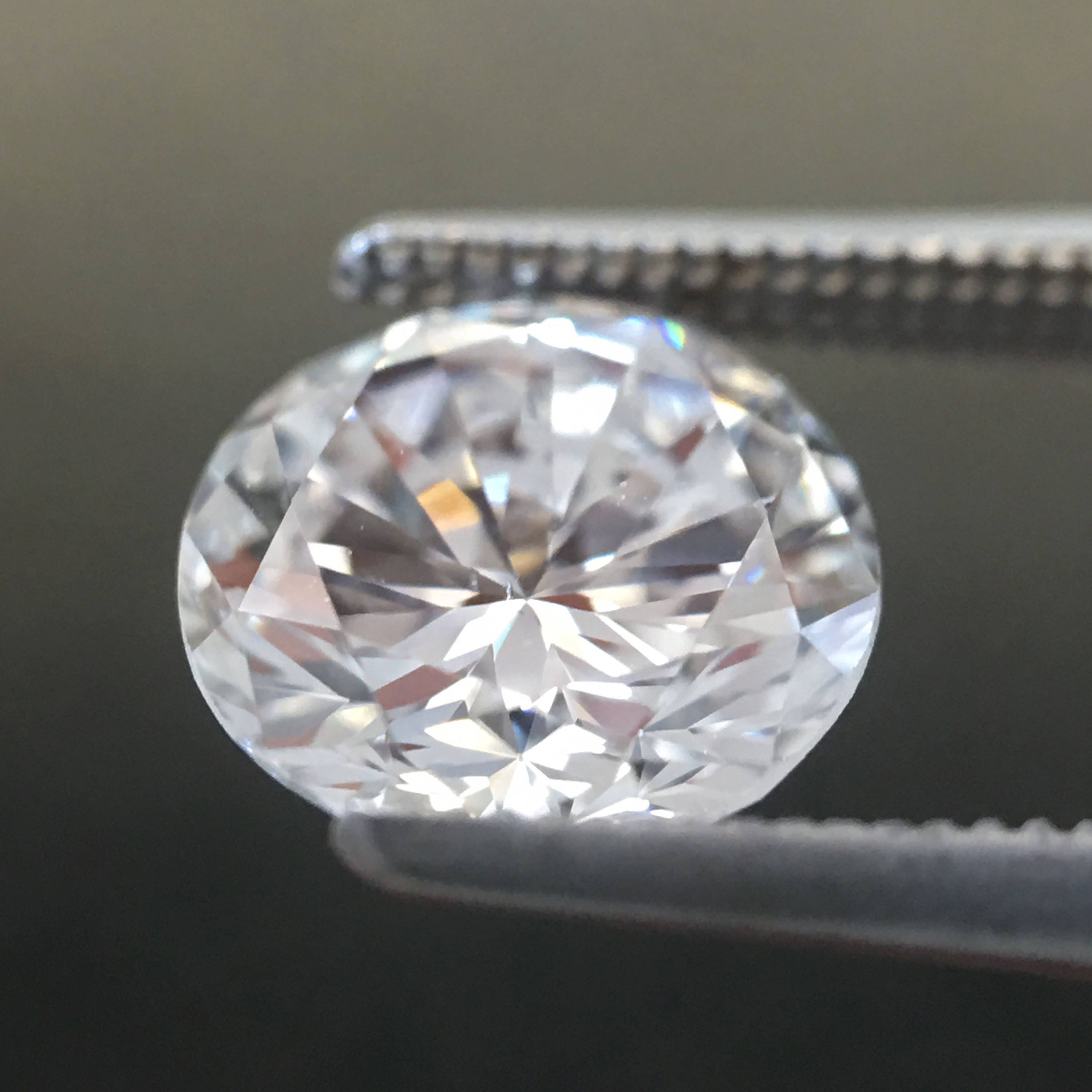 GIA Certified 0.88 CTW round brilliant diamond loose stone with E color and SI1 clarity, displayed on a neutral background.