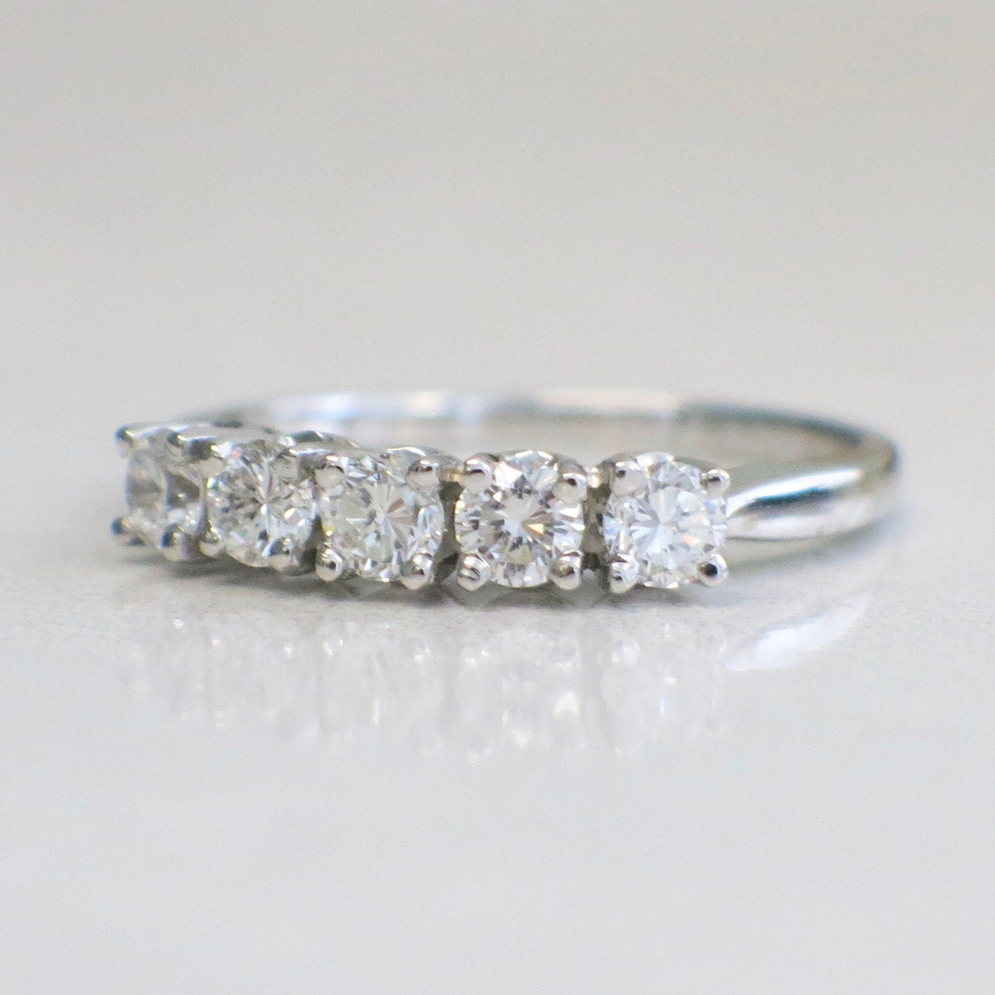 14K white gold five-stone diamond anniversary band with 0.70 carats total weight, SI1 F clarity, size 7, featuring sparkling diamonds.