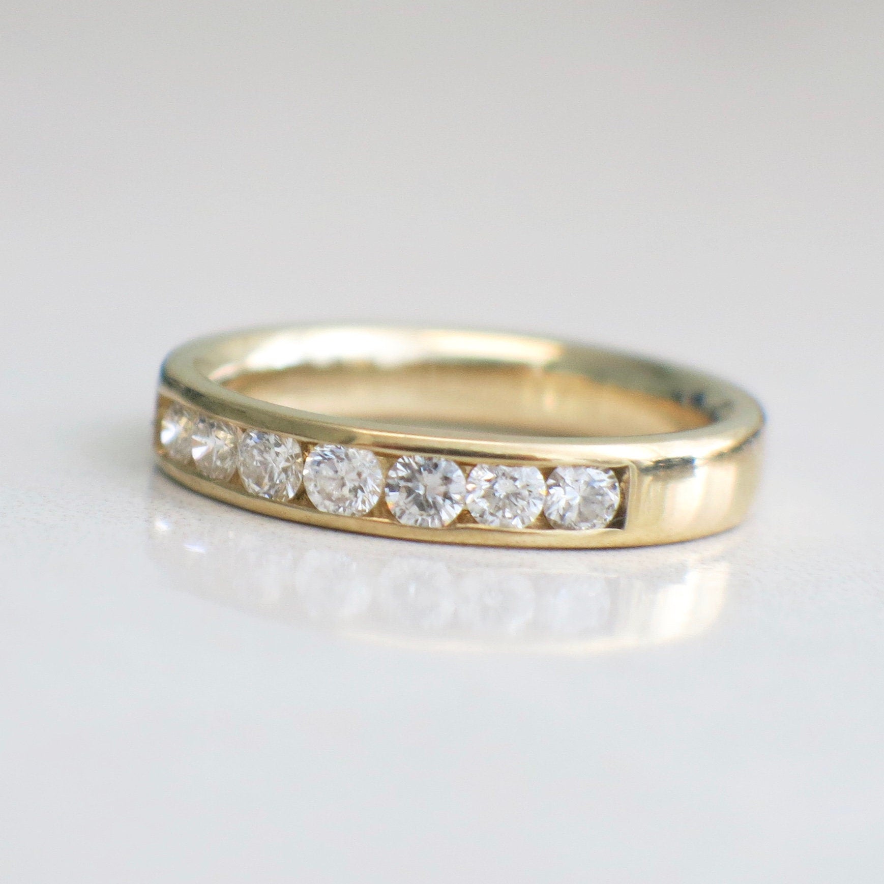 14K yellow gold diamond channel set band with .70 CTW, size 6, elegant diamond ring from Black Market LLC.