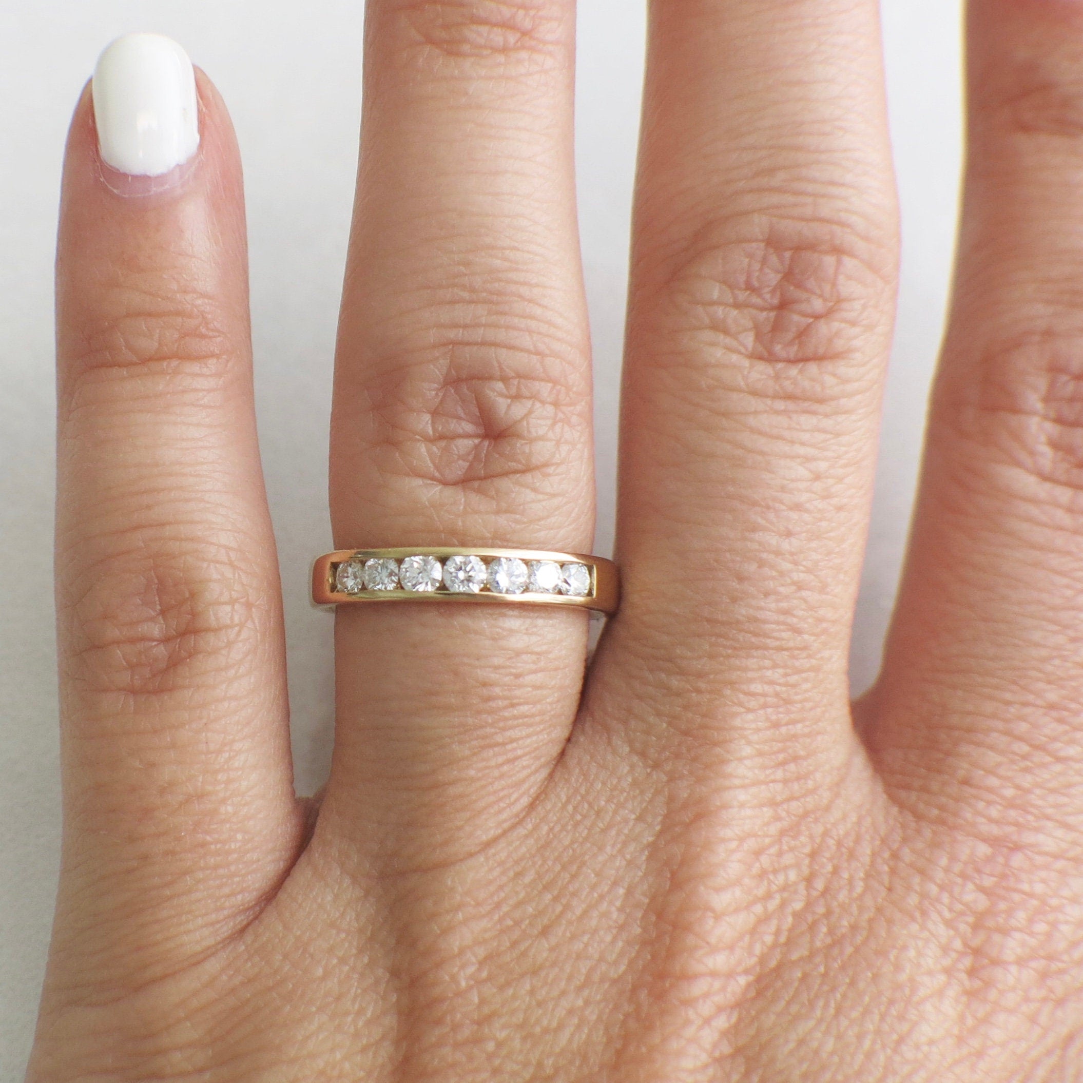 14K yellow gold diamond channel set band ring with .70 CTW, size 6, featuring sparkling diamonds in a sleek gold design.