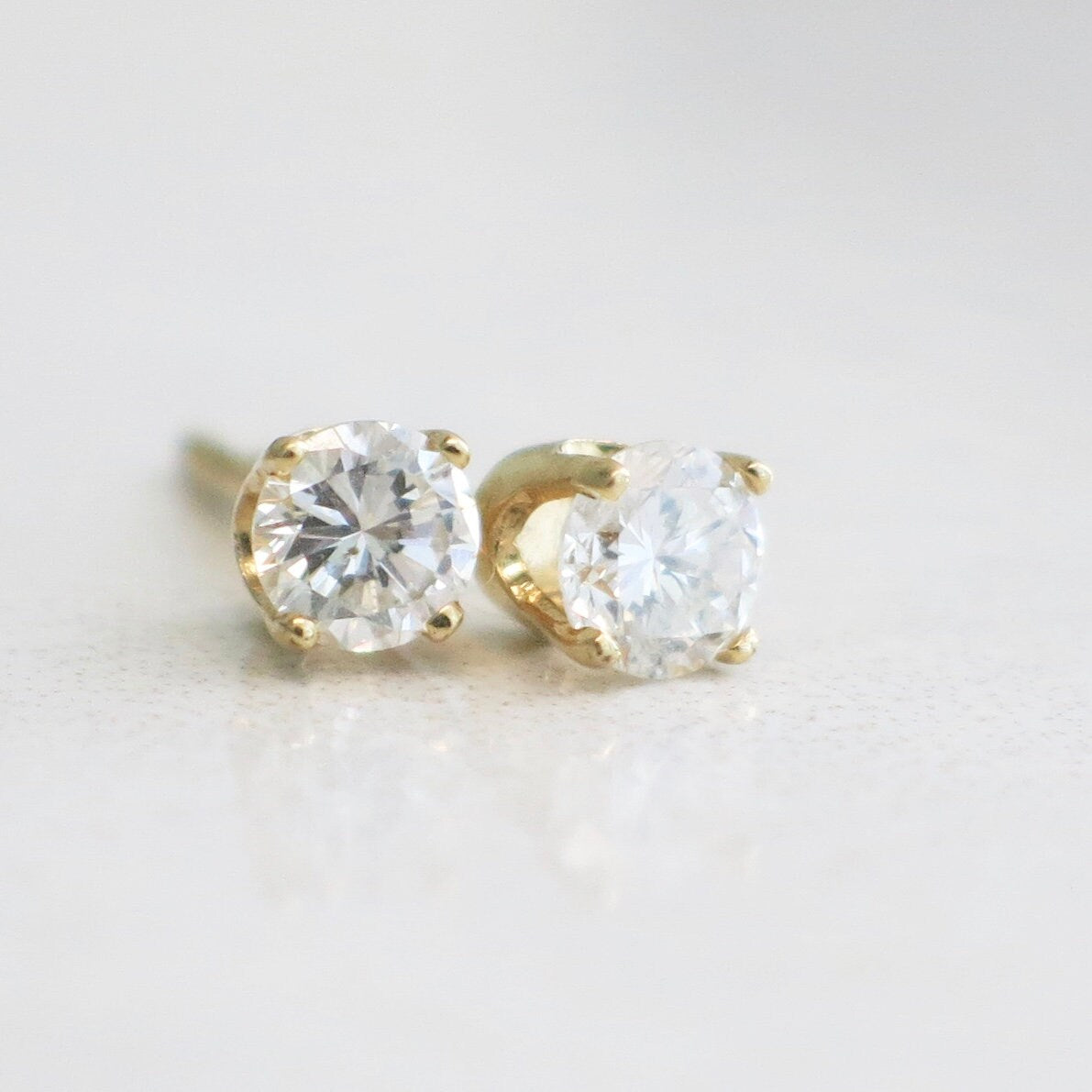 0.34ct diamond stud earrings in 14K yellow gold with round brilliant cut diamonds, featuring a classic and elegant design.