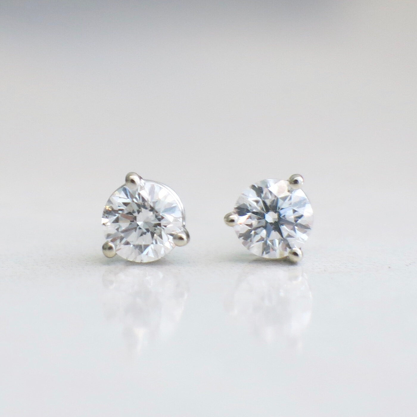 14K white gold diamond stud earrings with 0.76ct round brilliant diamonds in a classic martini setting.