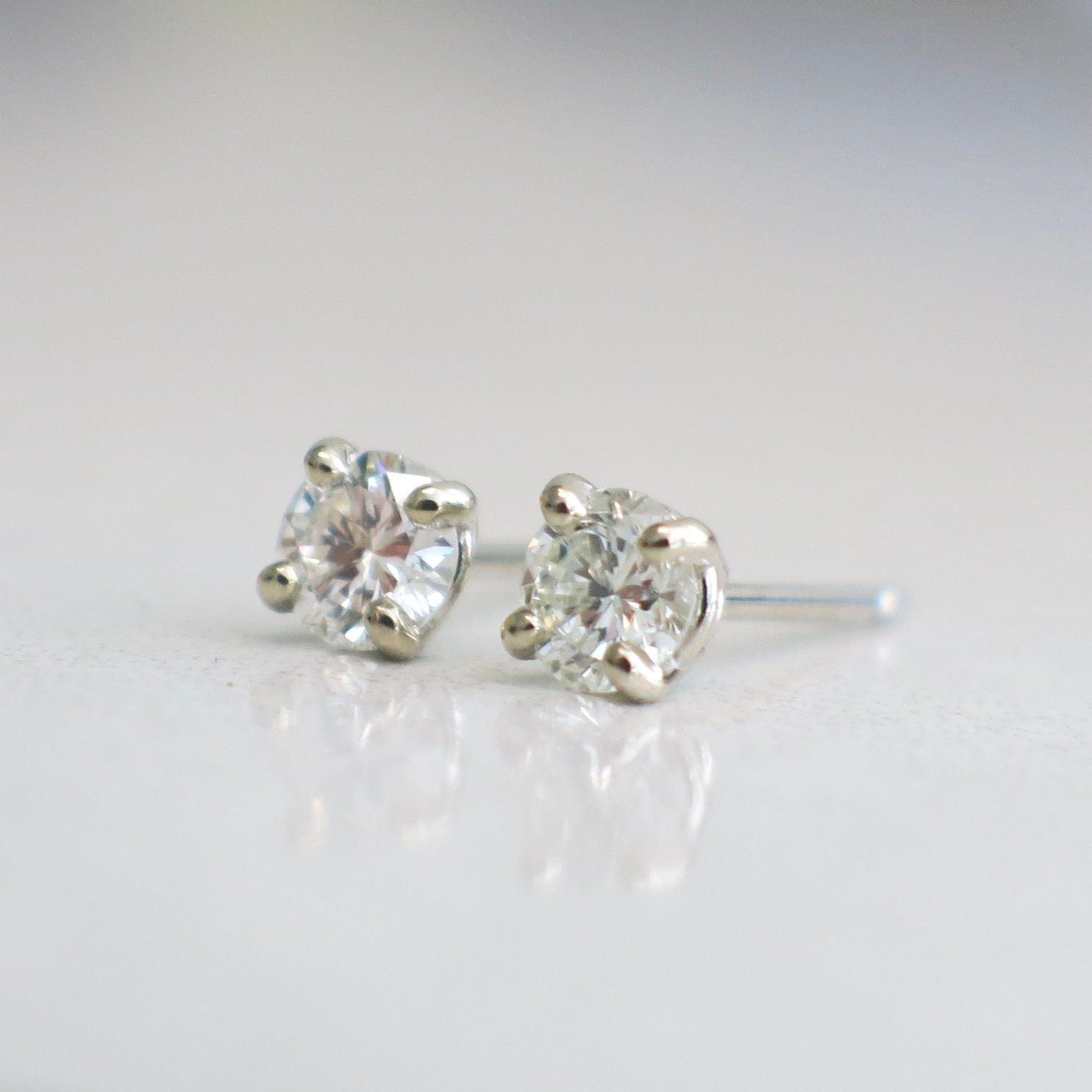 Diamond stud earrings with .45 CTW round brilliant diamonds set in 14K white gold, featuring classic elegance and sparkle.