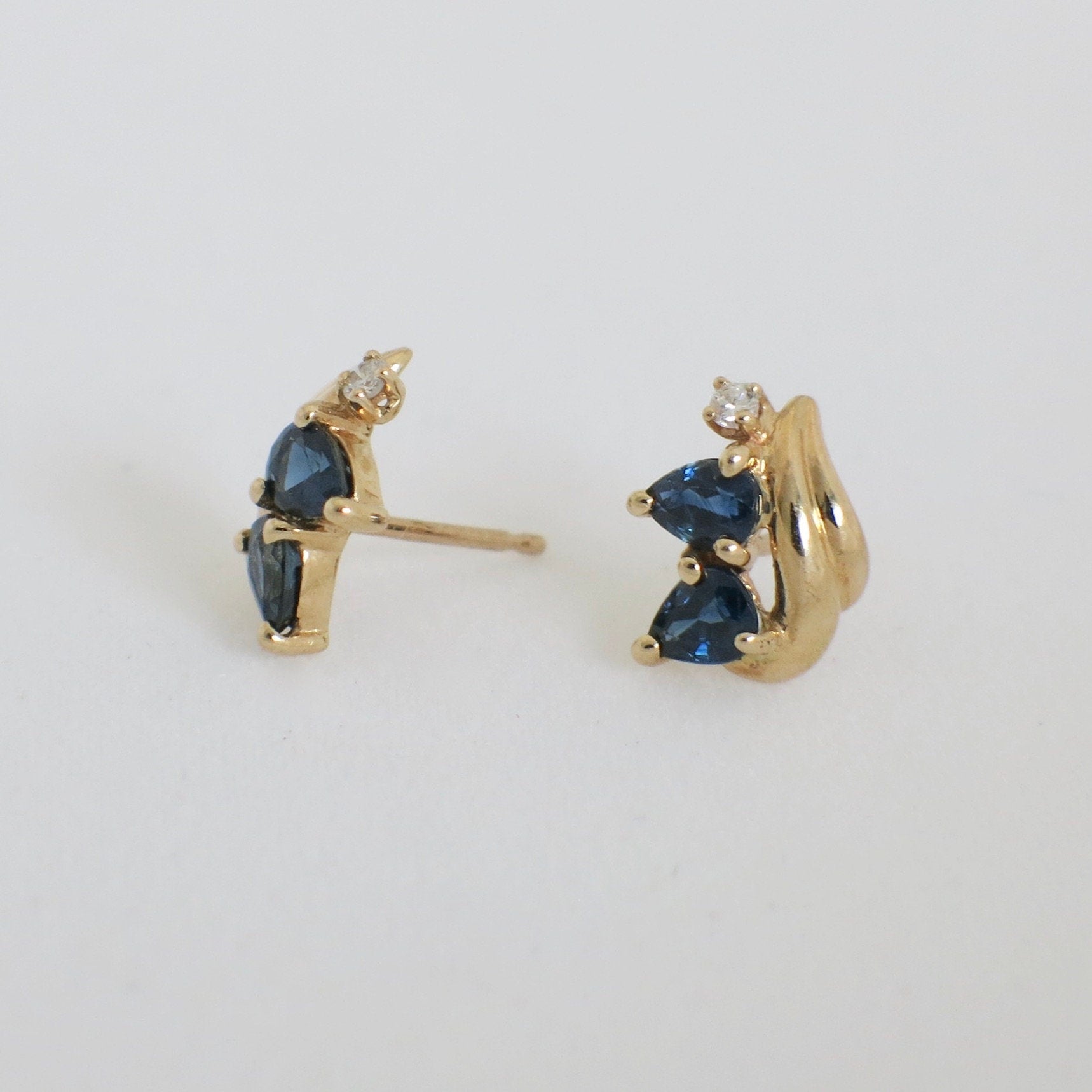 14K gold sapphire and diamond vintage stud earrings with yellow gold finish, featuring elegant gemstone accents.