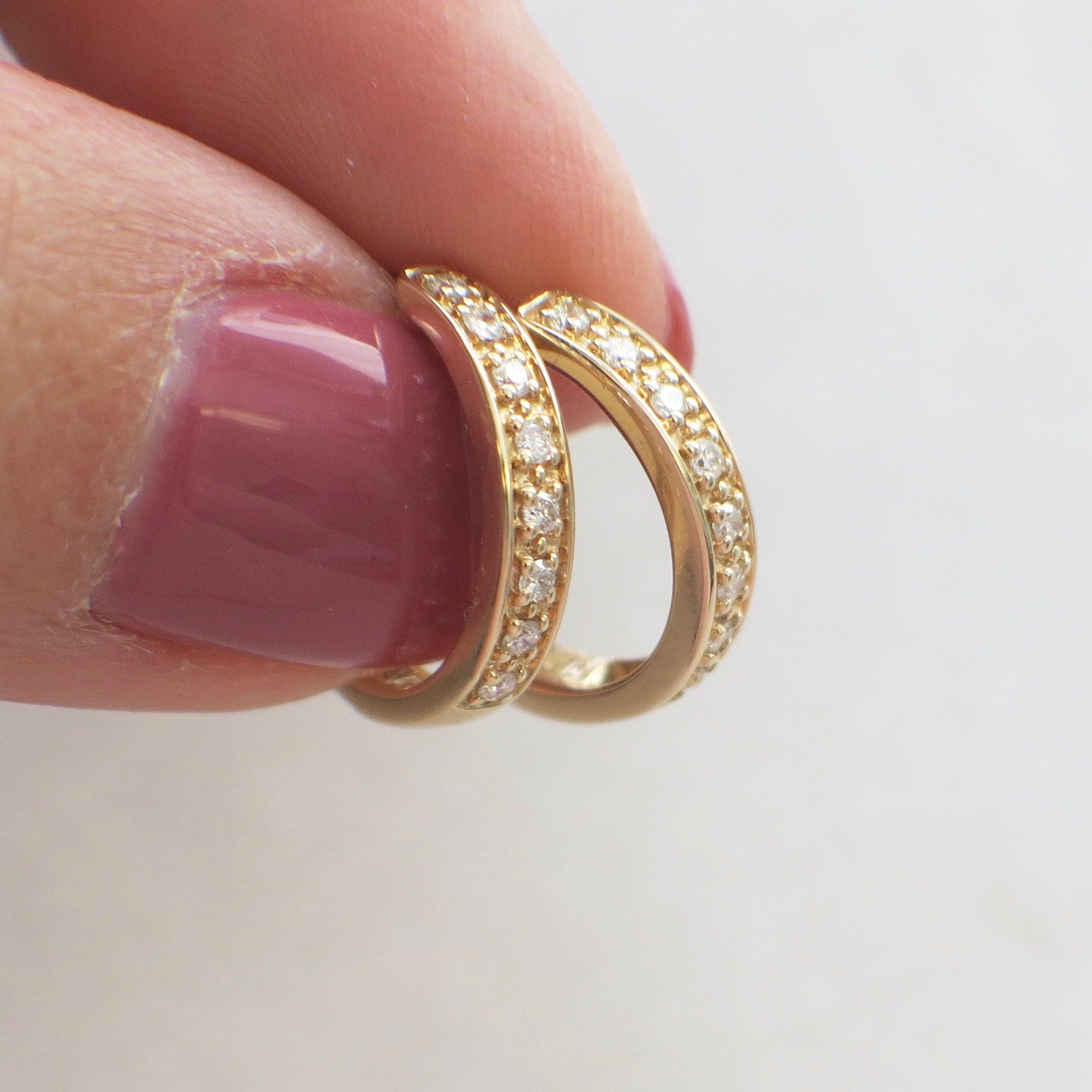 14K yellow gold diamond huggie hoop earrings by Black Market LLC, small dainty gold hoops with sparkling diamonds.