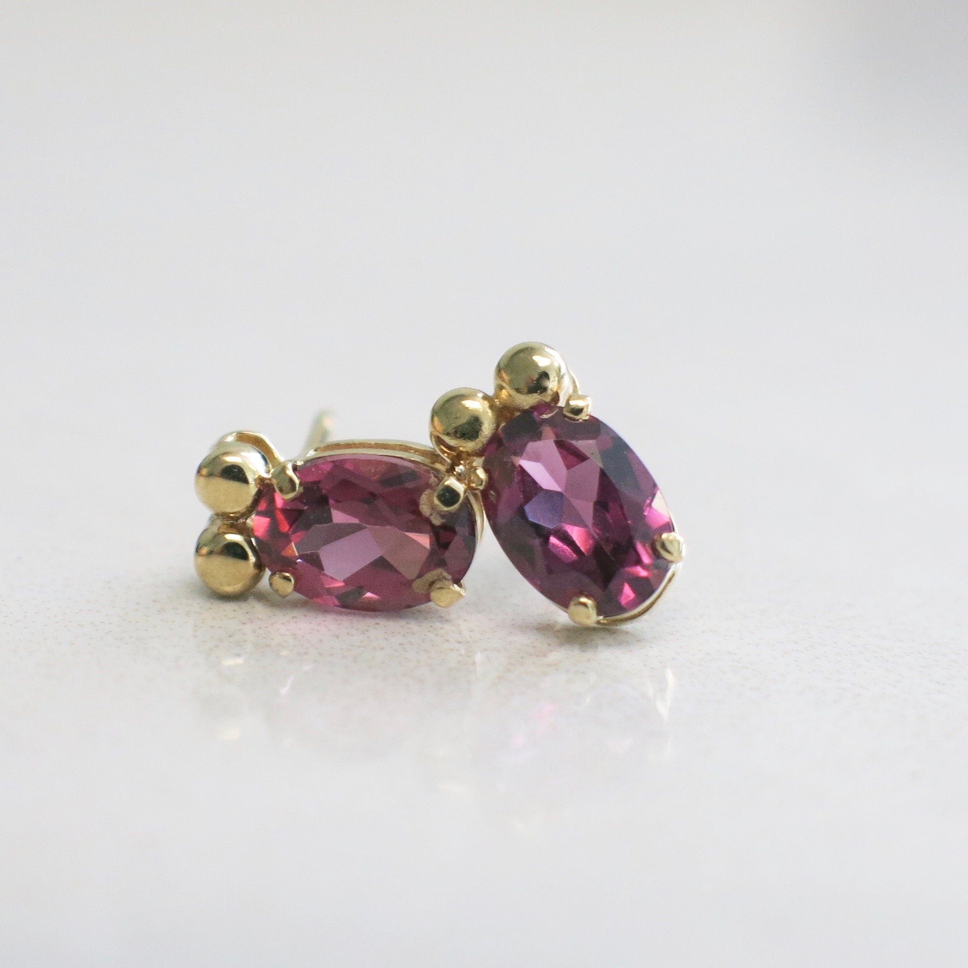 14K Yellow Gold Rhodolite Garnet Earrings | Oval Garnet Studs 7 x 5 mm - Black Market LLC
