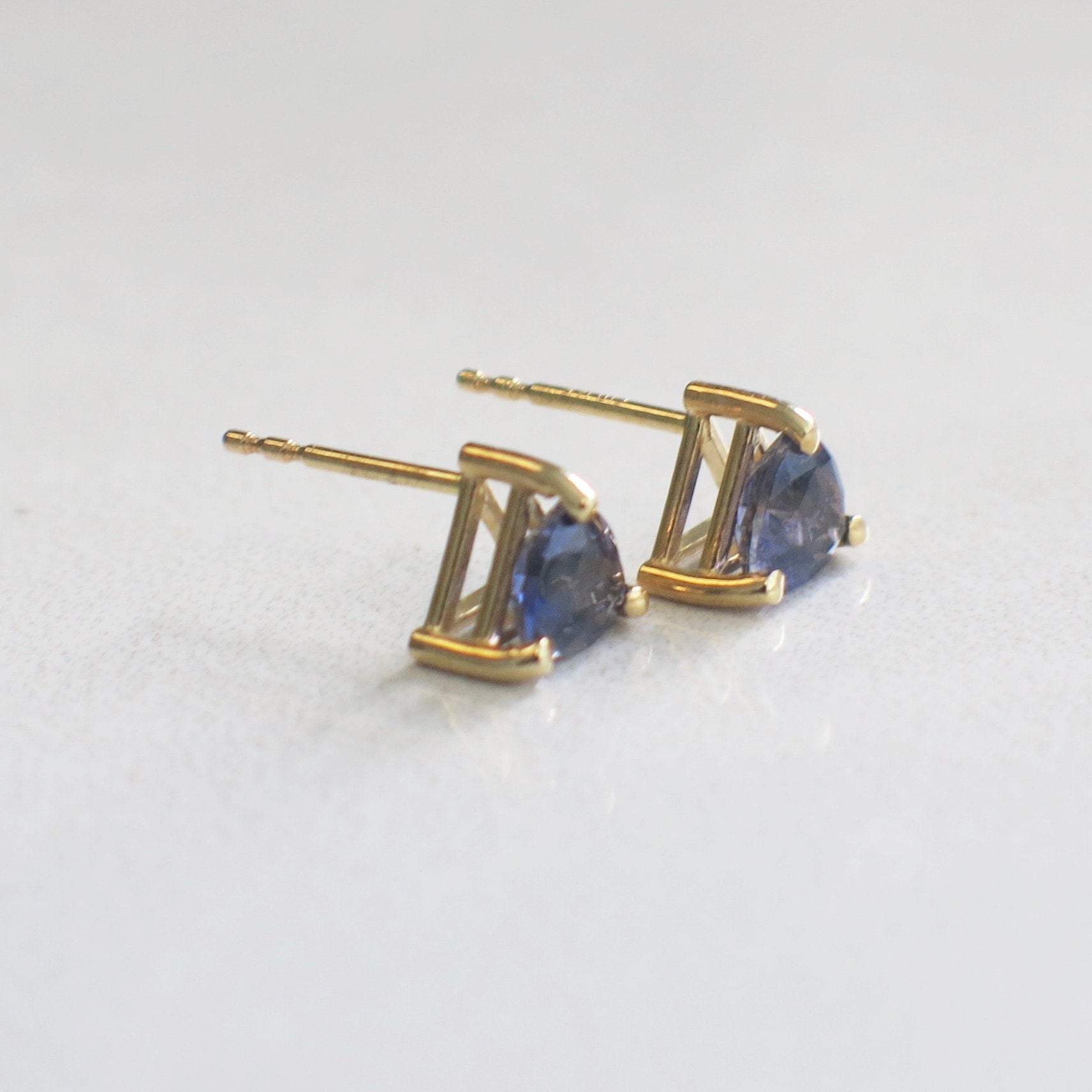 Triangular violet quartz stud earrings in 14K yellow gold with a 5mm cut, showcasing elegant gemstone and gold setting.