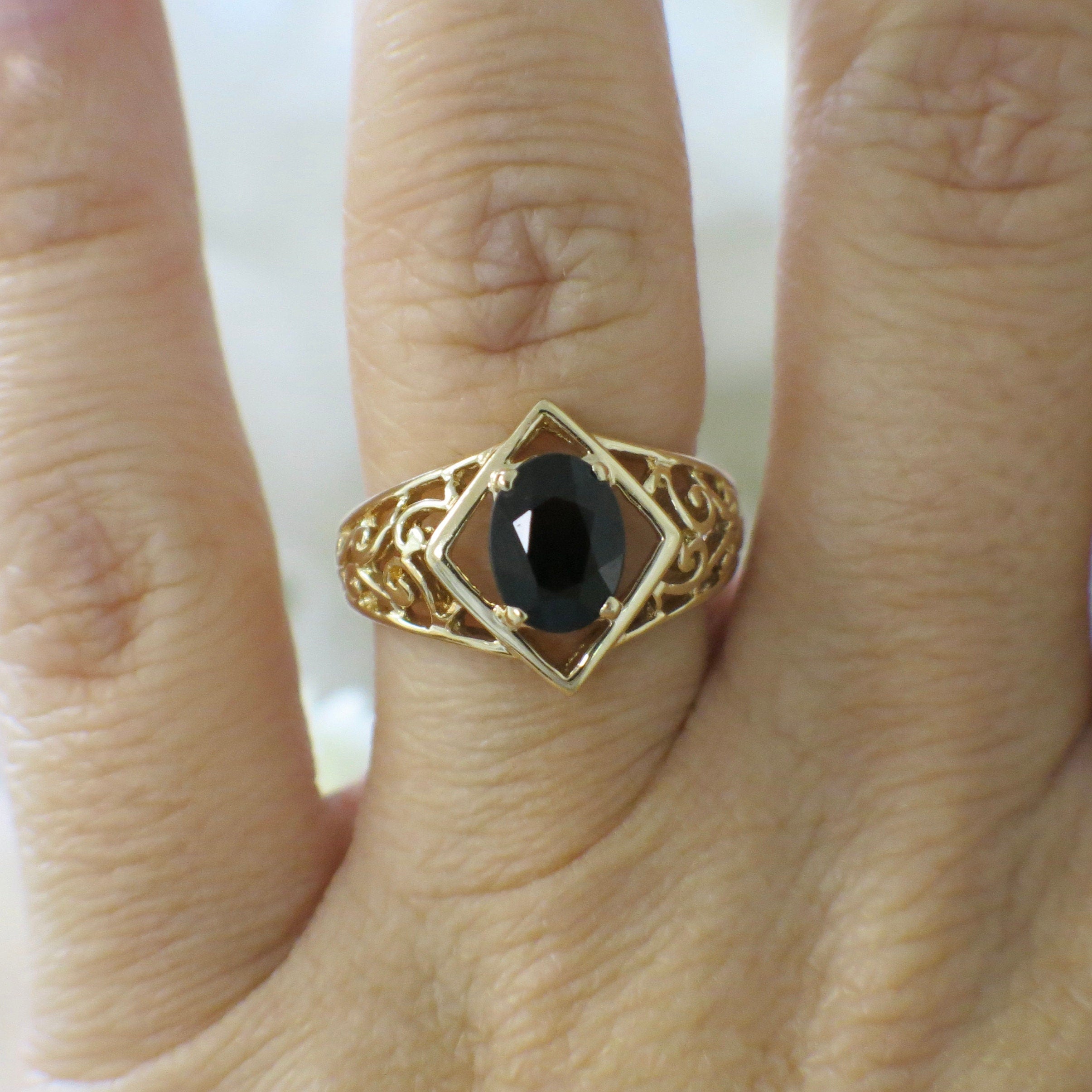 14K gold vintage garnet ring with oval garnet and scroll band design, size 6.25, by Black Market LLC.