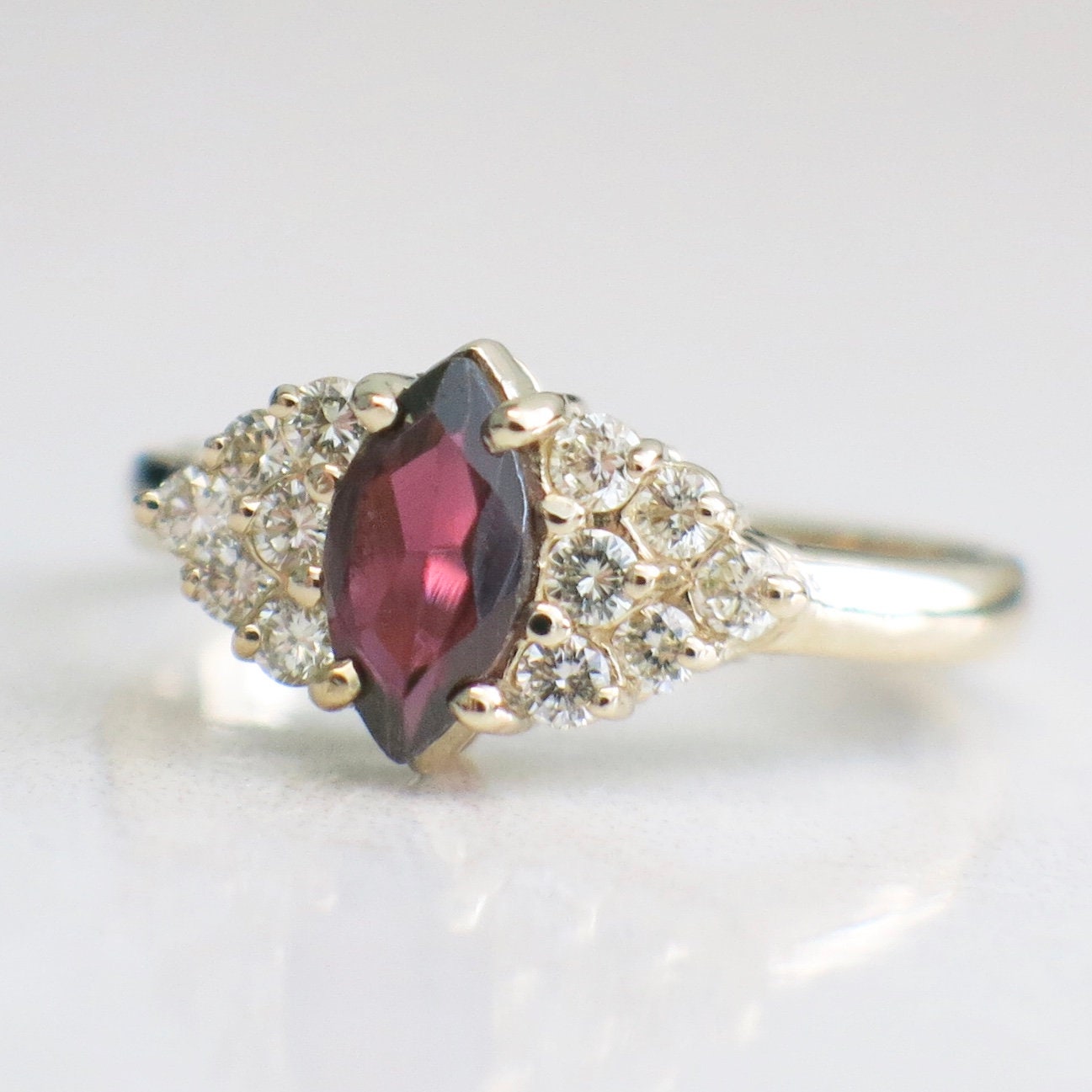 14K gold marquise garnet ring with diamond clusters, vintage style, size 6.5, showcasing elegant jewelry design.