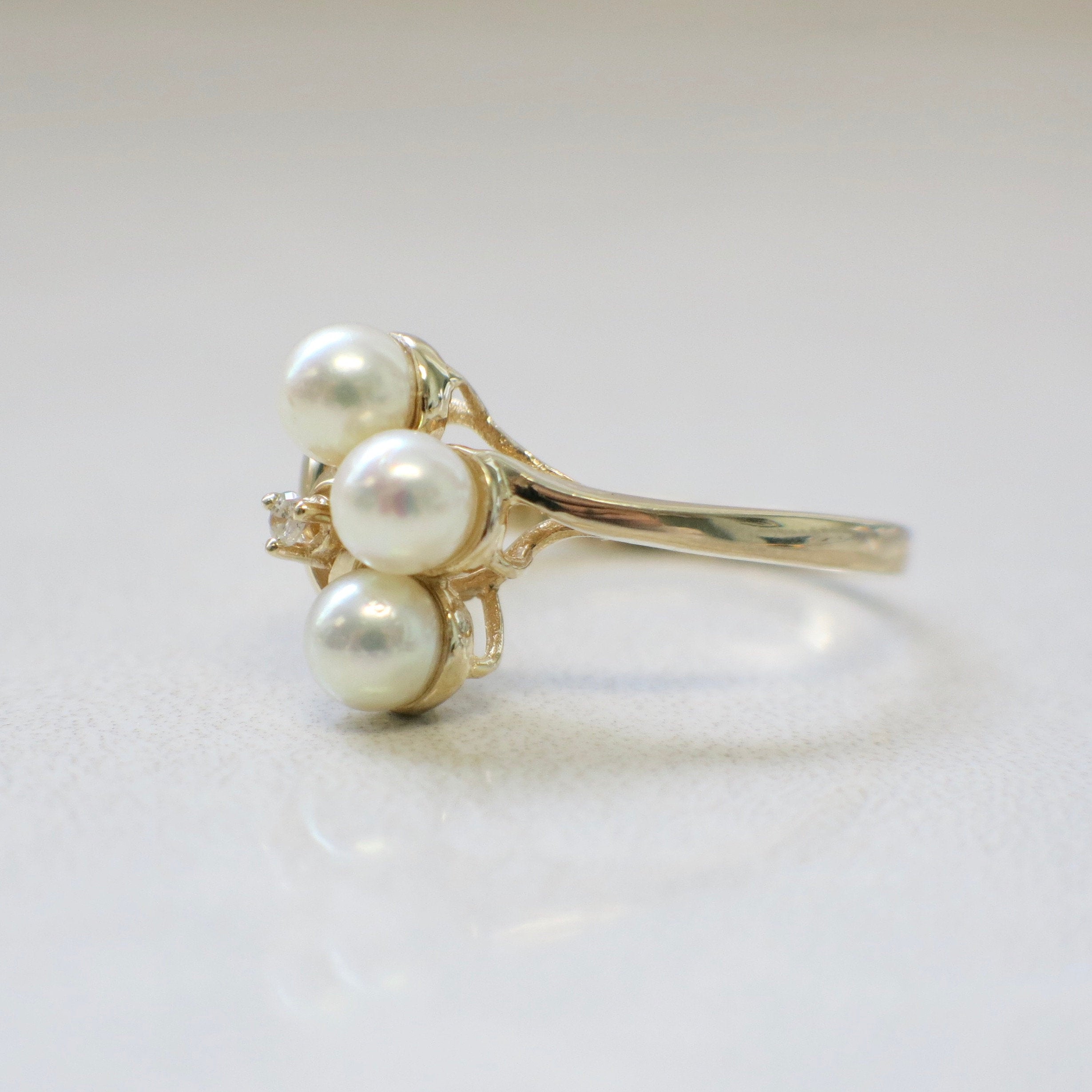 14K gold pearl and diamond ring by Black Market LLC featuring vintage trio pearl design, size 7.5, elegant jewelry piece.