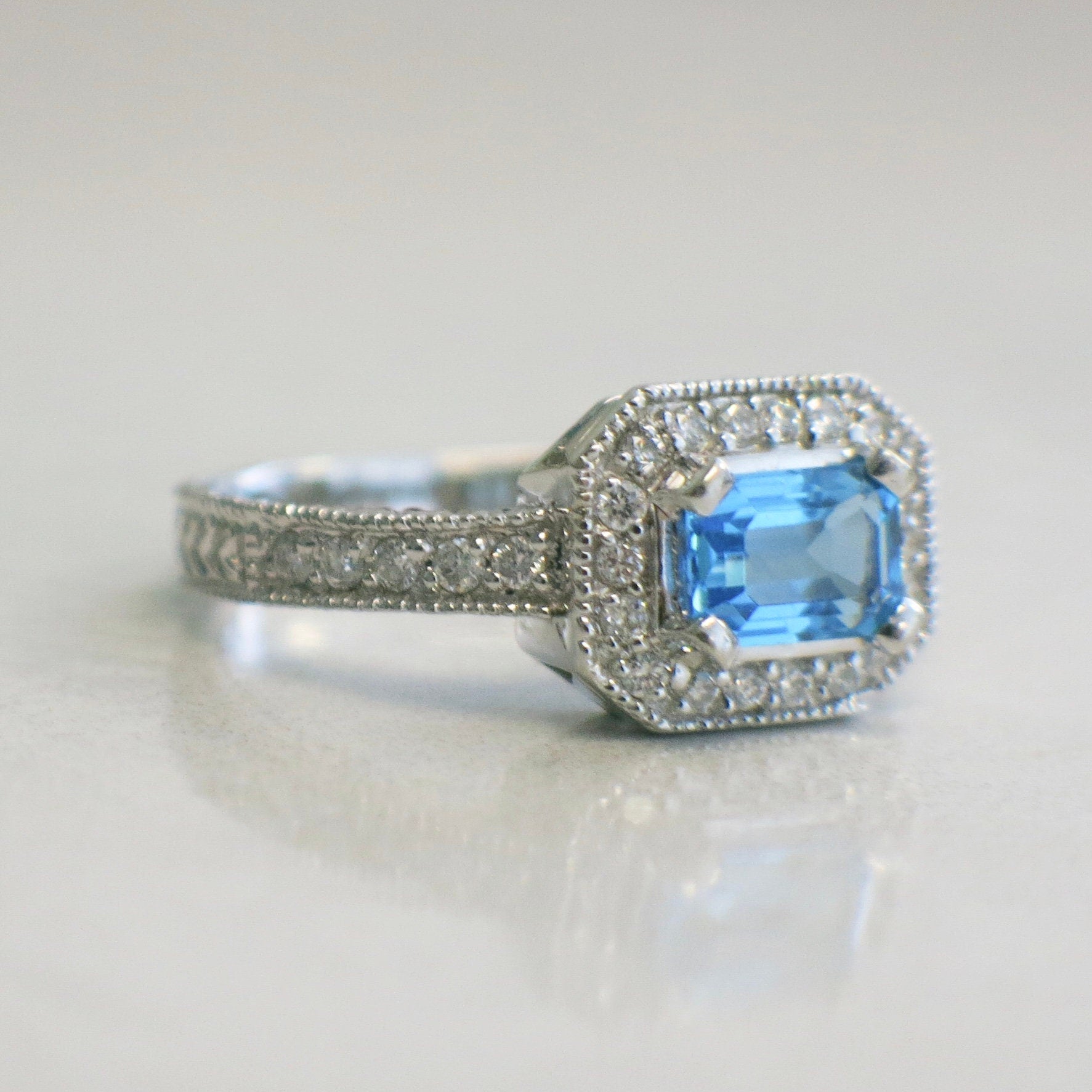 14K white gold Swiss blue topaz and diamond ring with east-west halo, size 8.5, featuring elegant gemstone design.