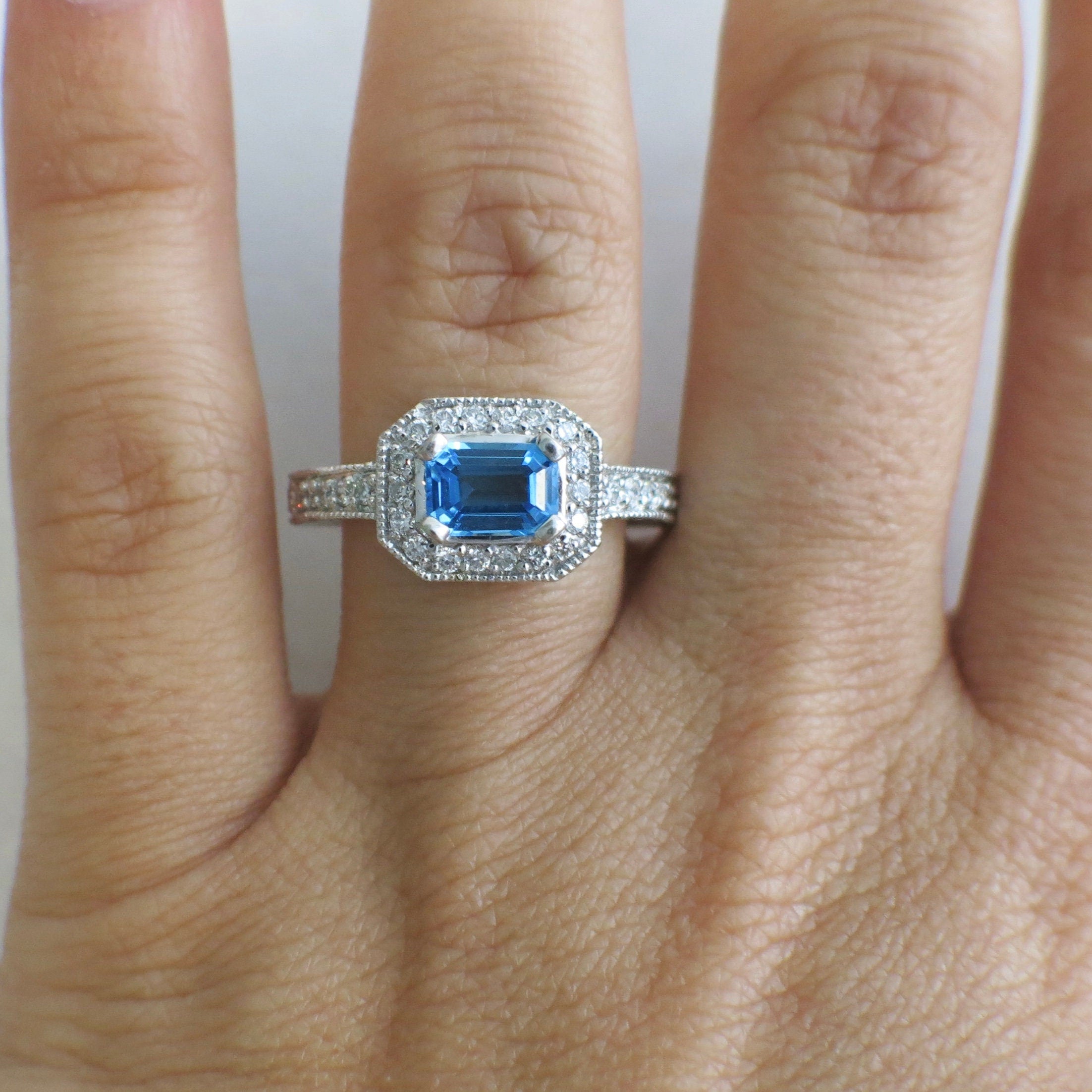 14K white gold Swiss blue topaz and diamond ring with east-west halo design, size 8.5, by Black Market LLC