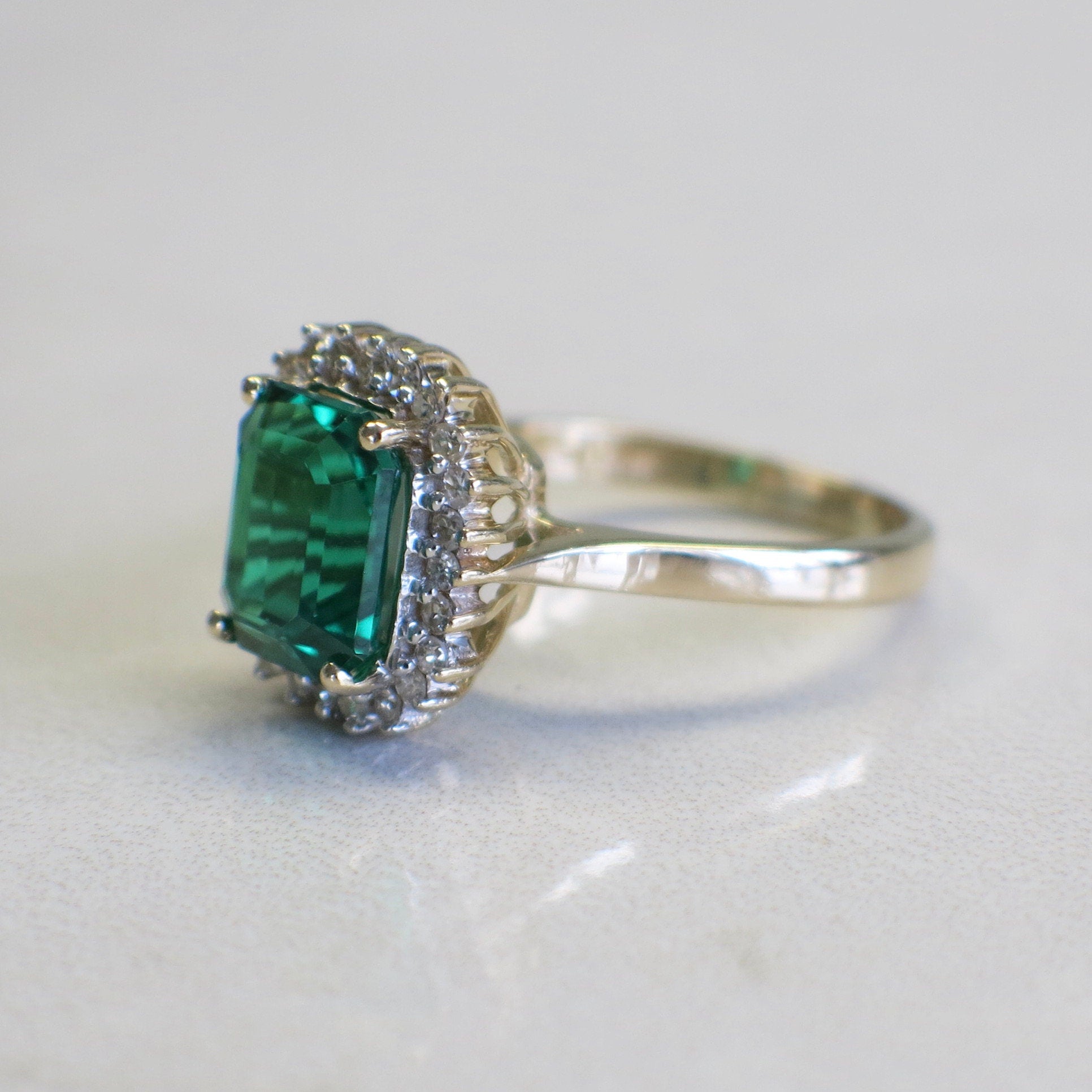 14K yellow gold vintage-inspired synthetic emerald and diamond halo ring, size 8.5, by Black Market LLC.