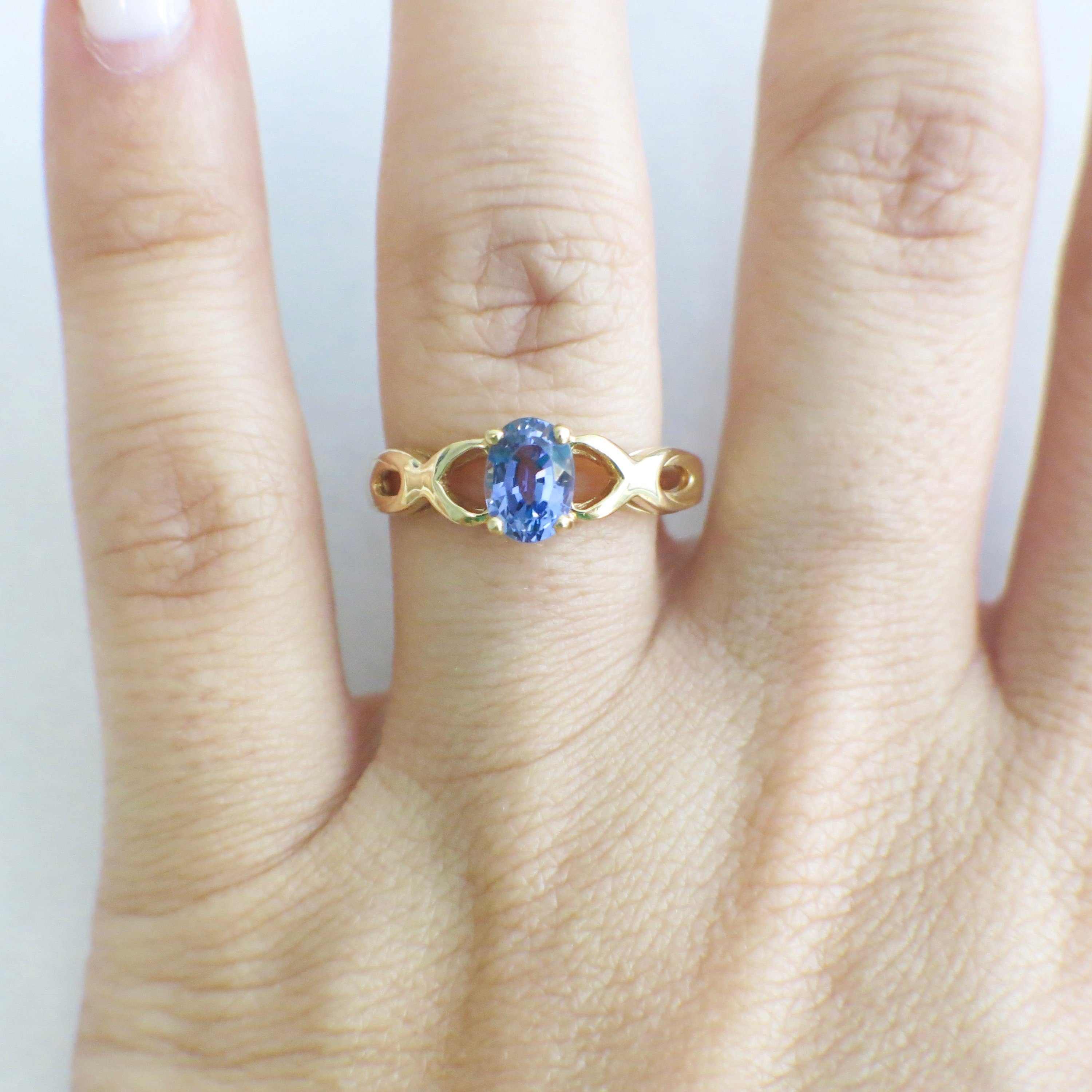 14K yellow gold Tanzanite oval ring with infinity twist band, December birthstone, size 8.5, by Black Market LLC.