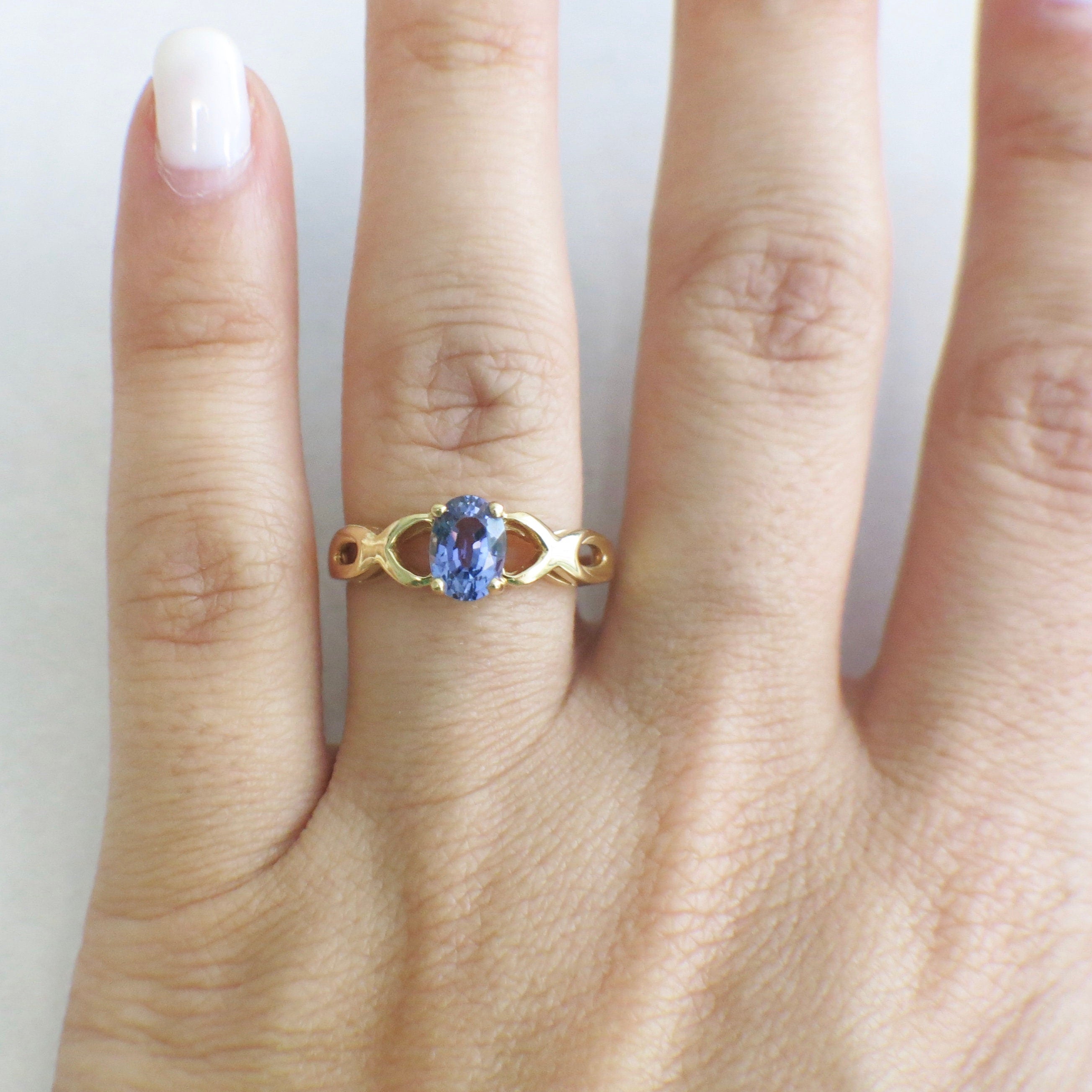 14K yellow gold Tanzanite oval ring with infinity twist band, December birthstone, size 8.5, by Black Market LLC.
