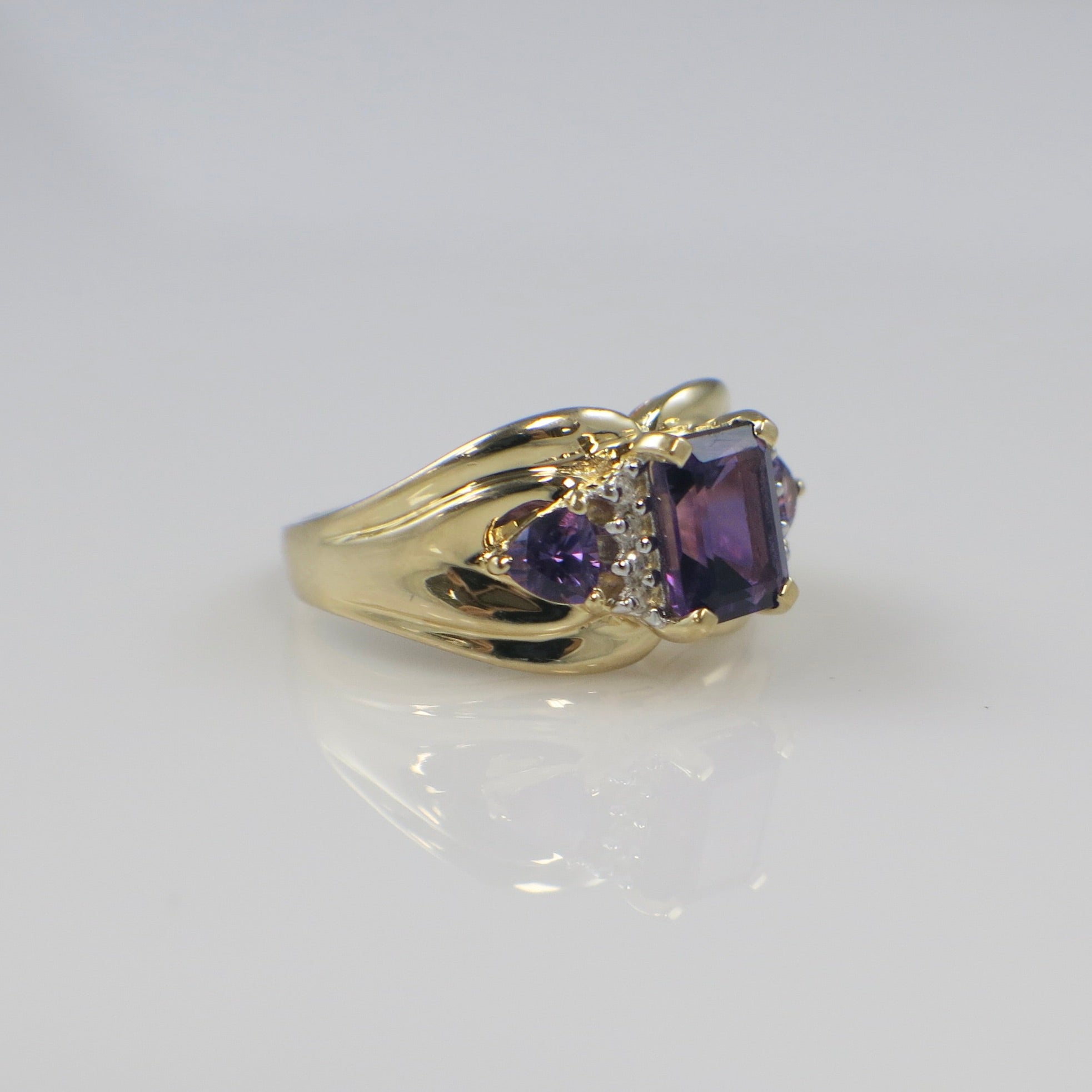 14K yellow gold Town and Country ring featuring an emerald cut amethyst center stone with diamond side stones, size 8.5.