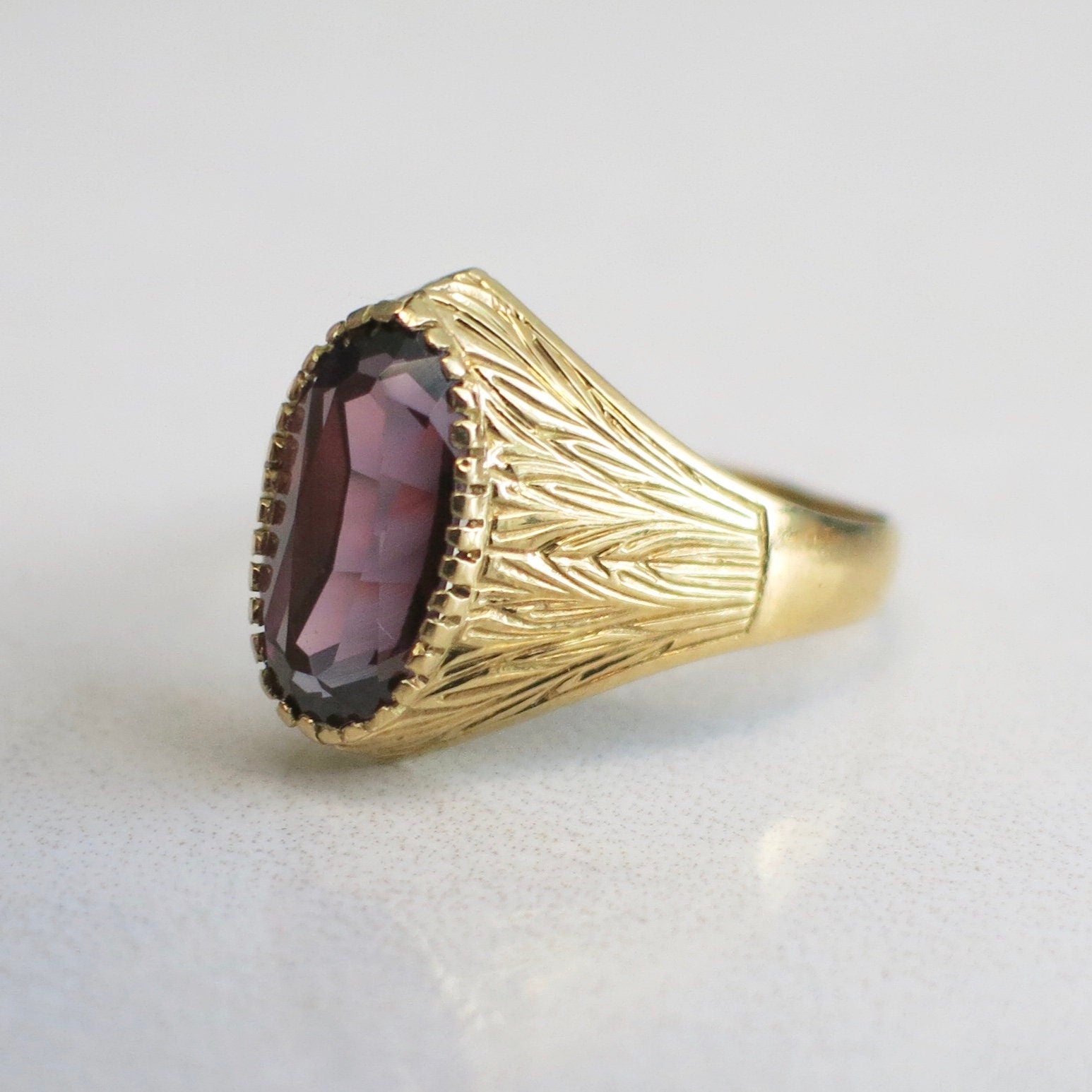 18K gold purple sapphire ring with vintage carved bezel, oval domed design, size 8.5, by Black Market LLC.