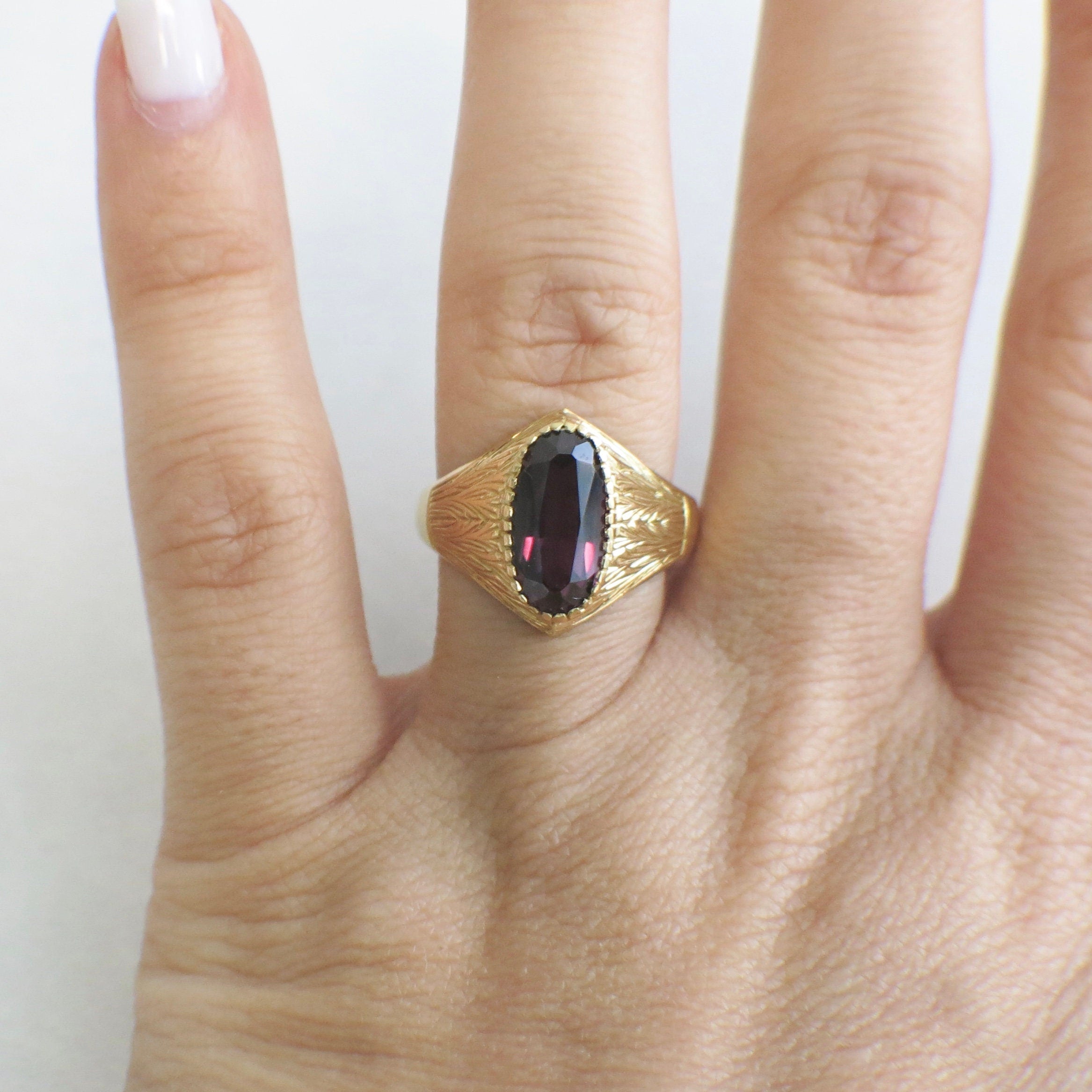 18K gold purple sapphire ring with vintage carved bezel and oval domed design, size 8.5, by Black Market LLC.