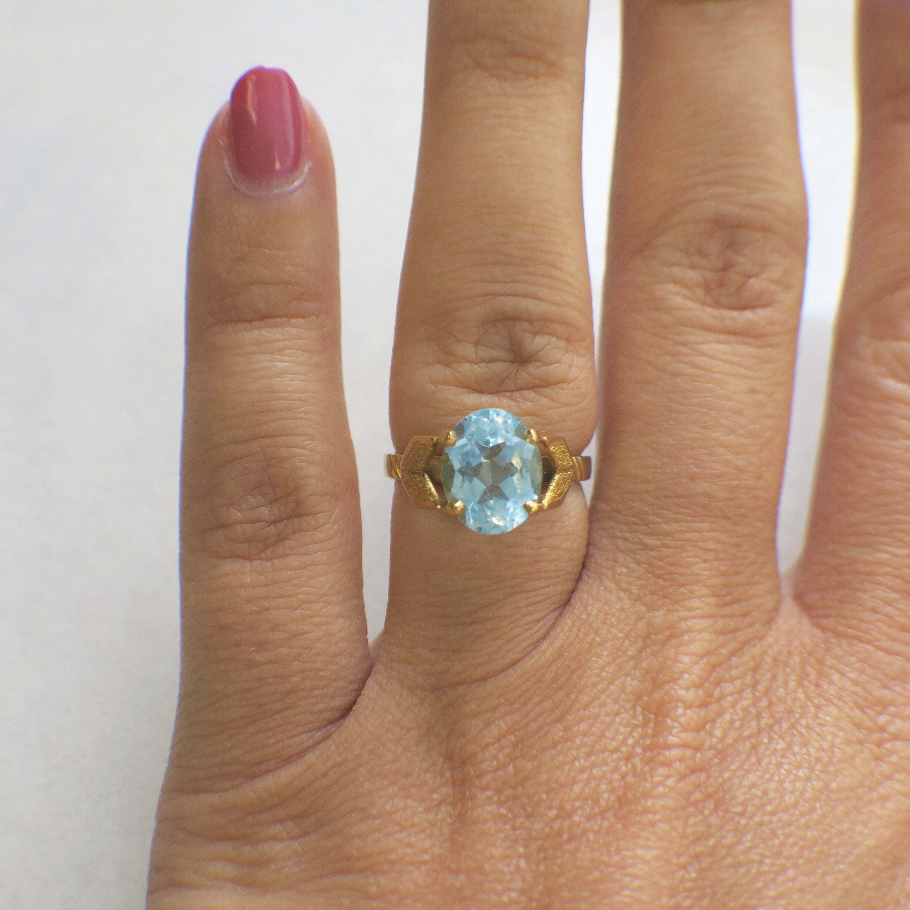 Large aquamarine oval solitaire ring in 18K yellow gold with vintage style, size 4.75, featuring a prominent central gemstone.