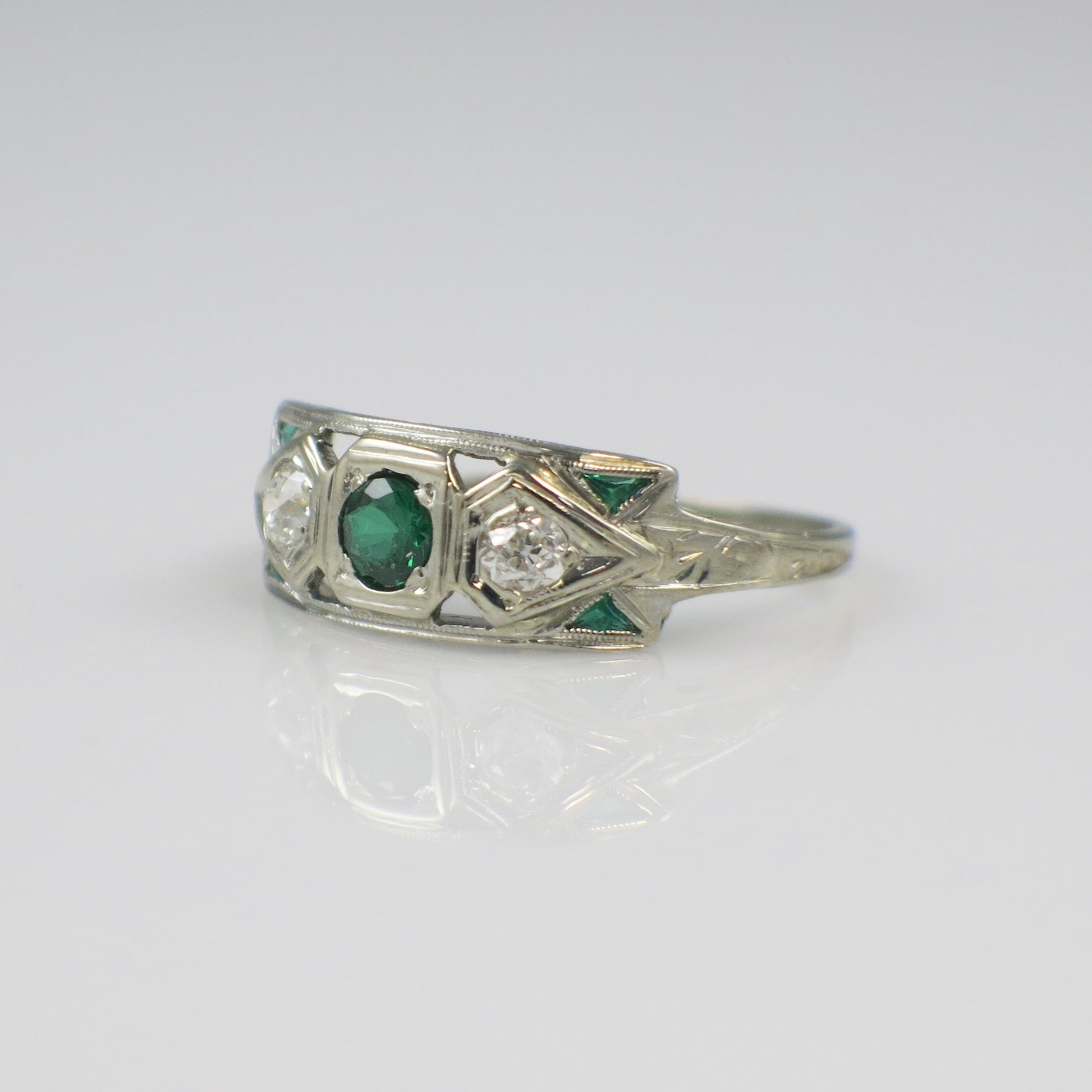 Vintage 14K white gold Art Deco ring featuring tsavorite garnet and old European cut diamonds.